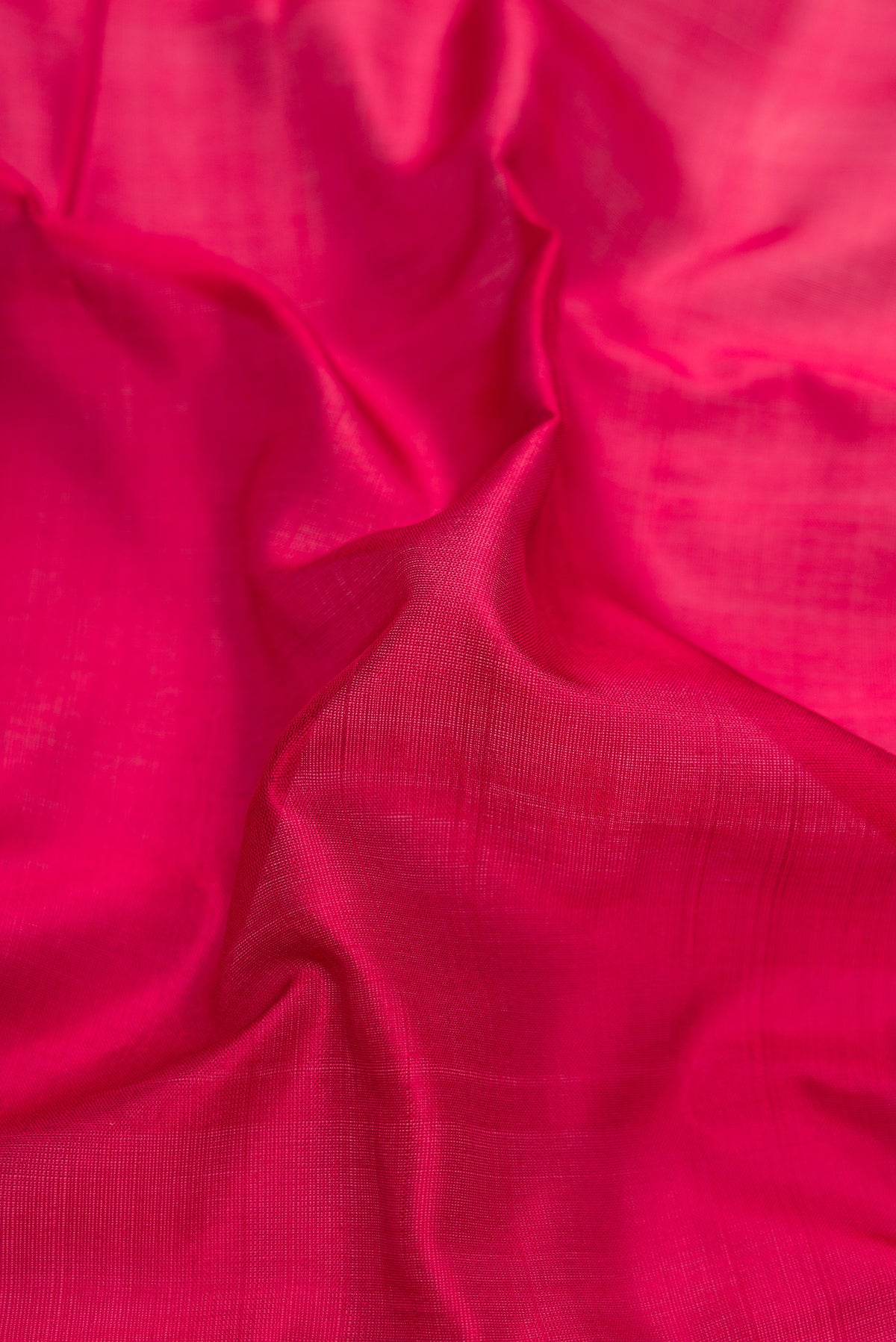 Close up of Maroon Kanchipuram Silk Saree with Plain Body and Thread Border.  displaying folds