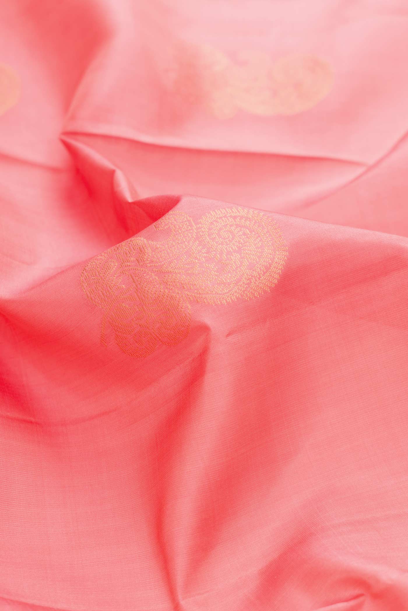 Close up of Peach Dual Tone Soft Silk Saree with Zari Butta on the body and Zari Border displaying folds