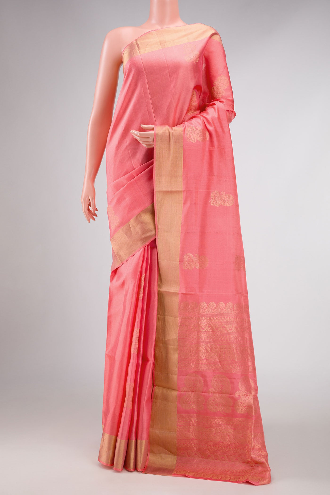 Peach Dual Tone Soft Silk Saree with Zari Butta on the body and Zari Border displayed on a mannequin