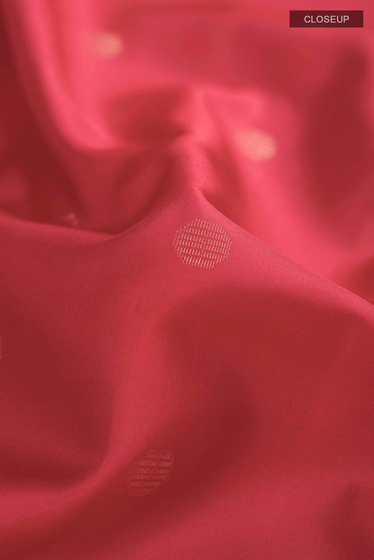 Close up of Red Soft Silk Saree with Zari Butta on the body and Zari Border displaying folds