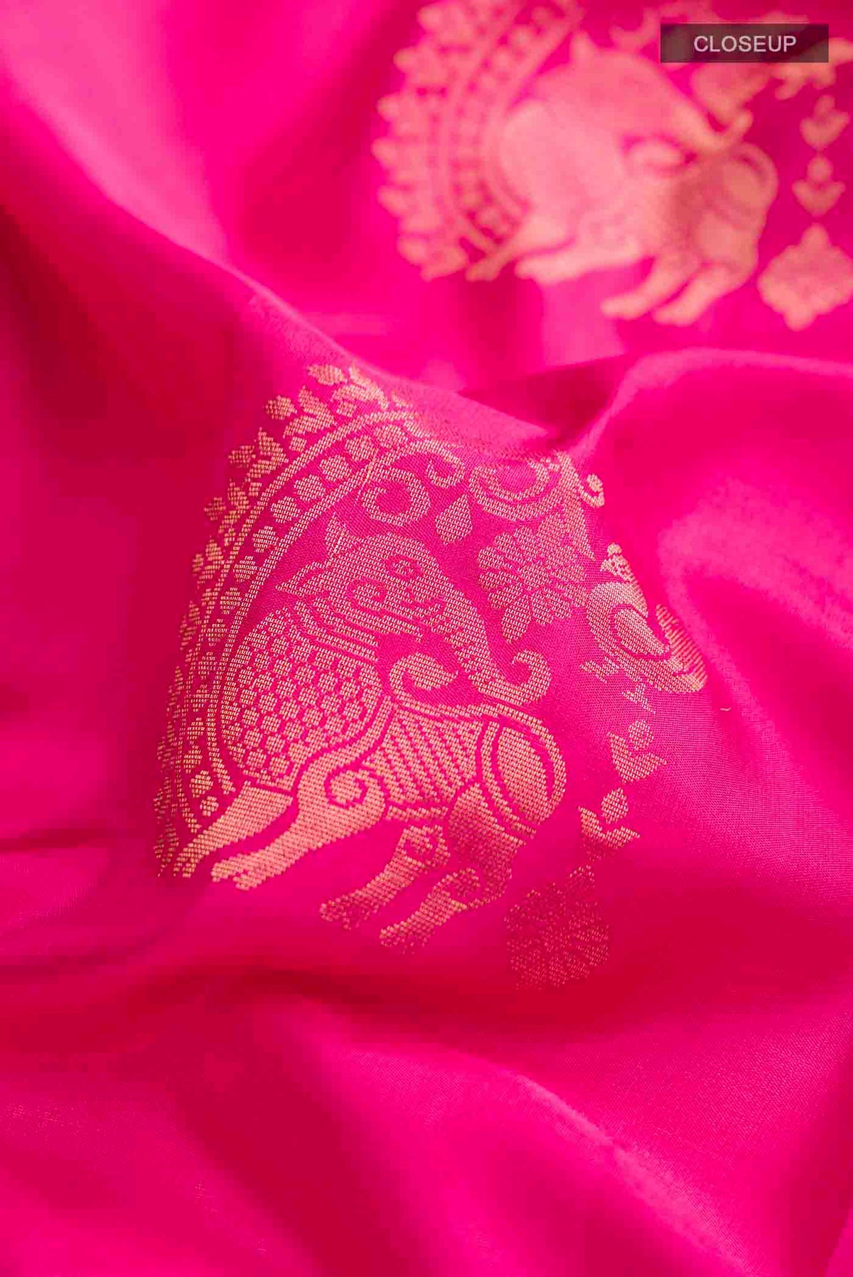 Close up of Pink Soft Silk Saree with Zari Butta on the body and Zari Border displaying folds