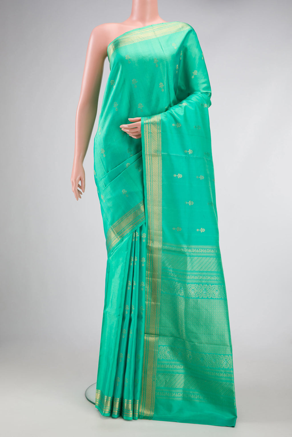 Sea Green Dual Tone Soft Silk Saree with Zari Butta on the body and Zari Border.  displayed on a mannequin