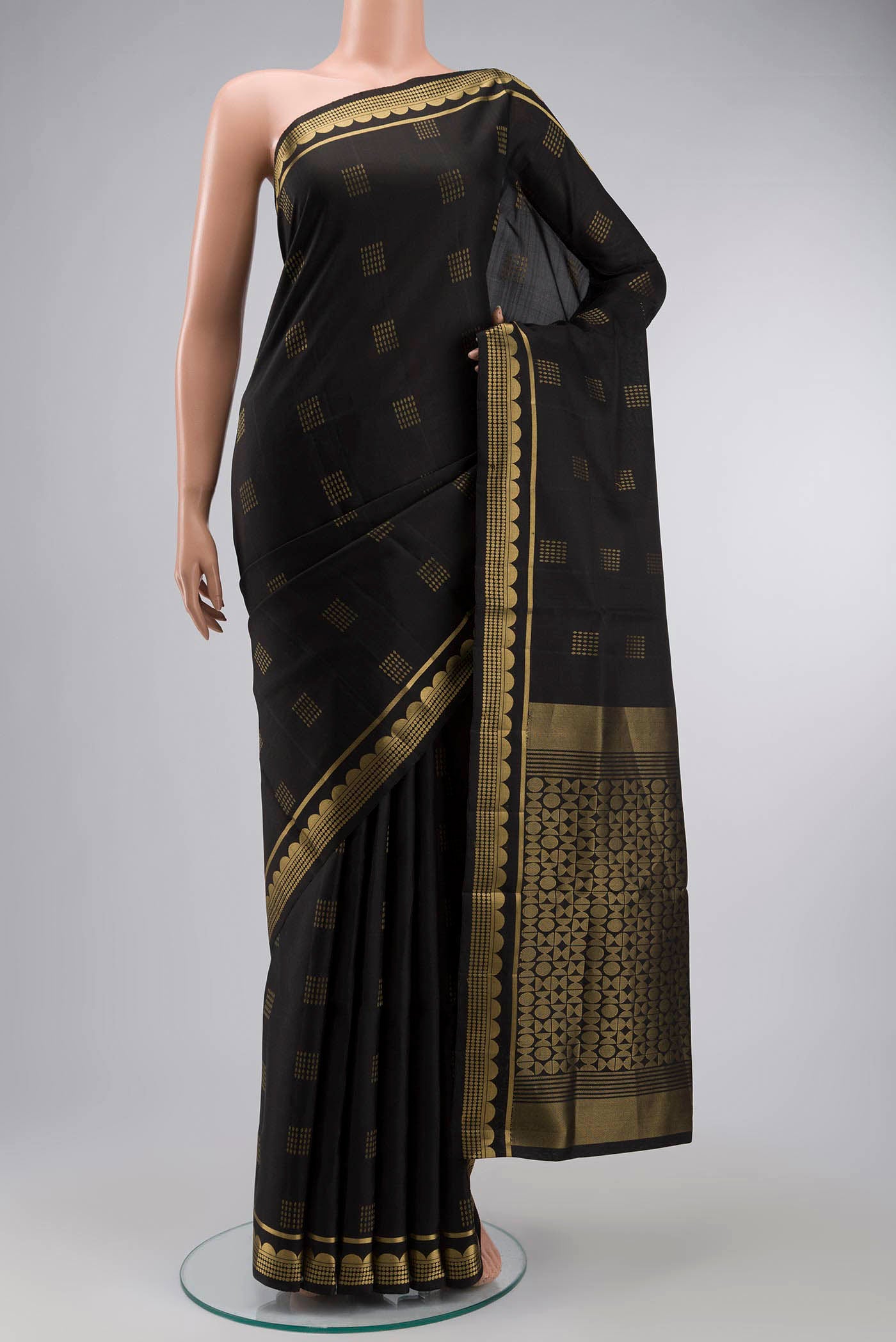 Black Soft Silk Saree with Zari Butta on the body and Zari Border displayed on a mannequin