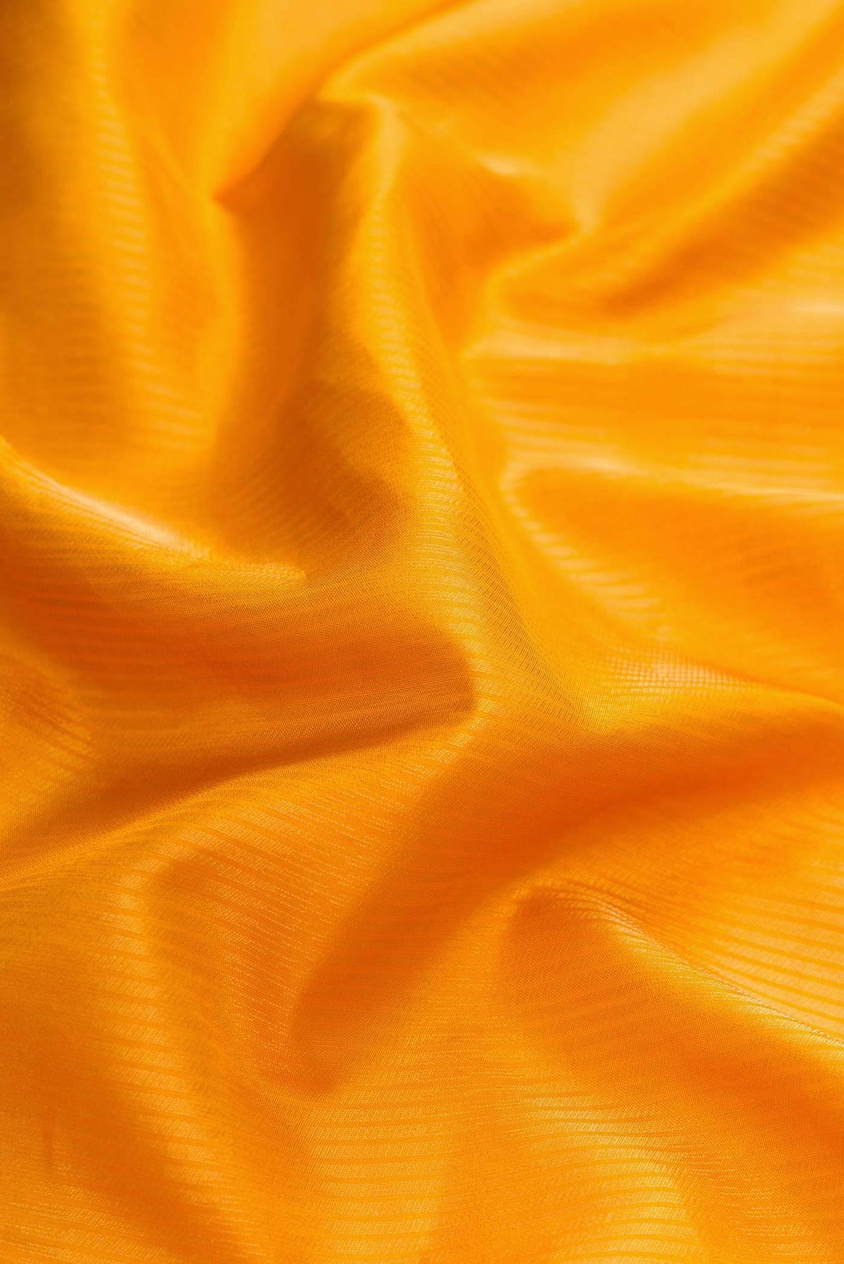 Close up of Mustard Dual Tone Soft Silk Saree with Zari Brocade on the body and Zari Border displaying folds