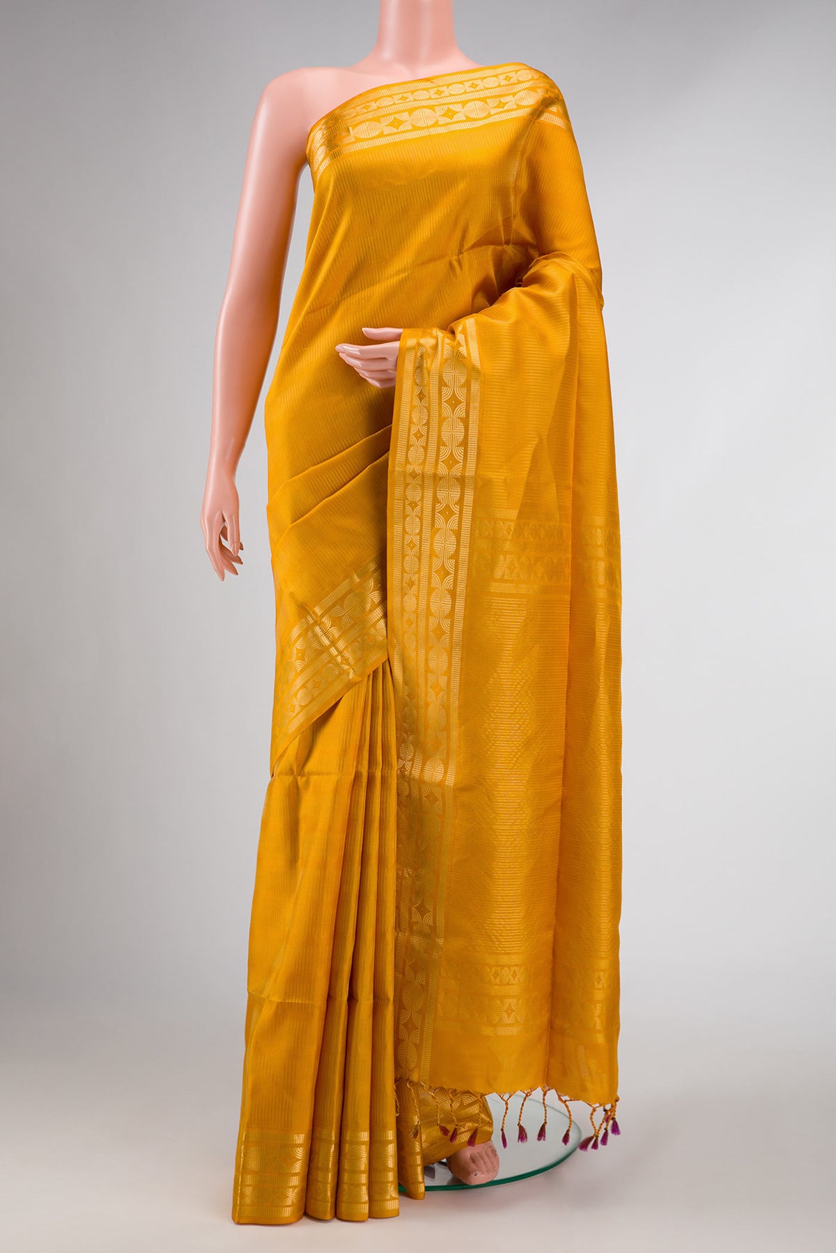 Mustard Dual Tone Soft Silk Saree with Zari Brocade on the body and Zari Border displayed on a mannequin