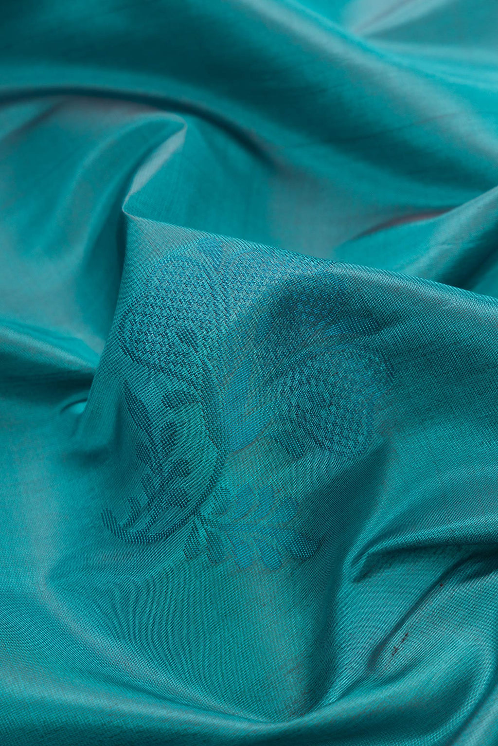 Close up of Peacock Blue Dual Tone Soft Silk Saree with Thread Butta on the body and Plain Border.  displaying folds