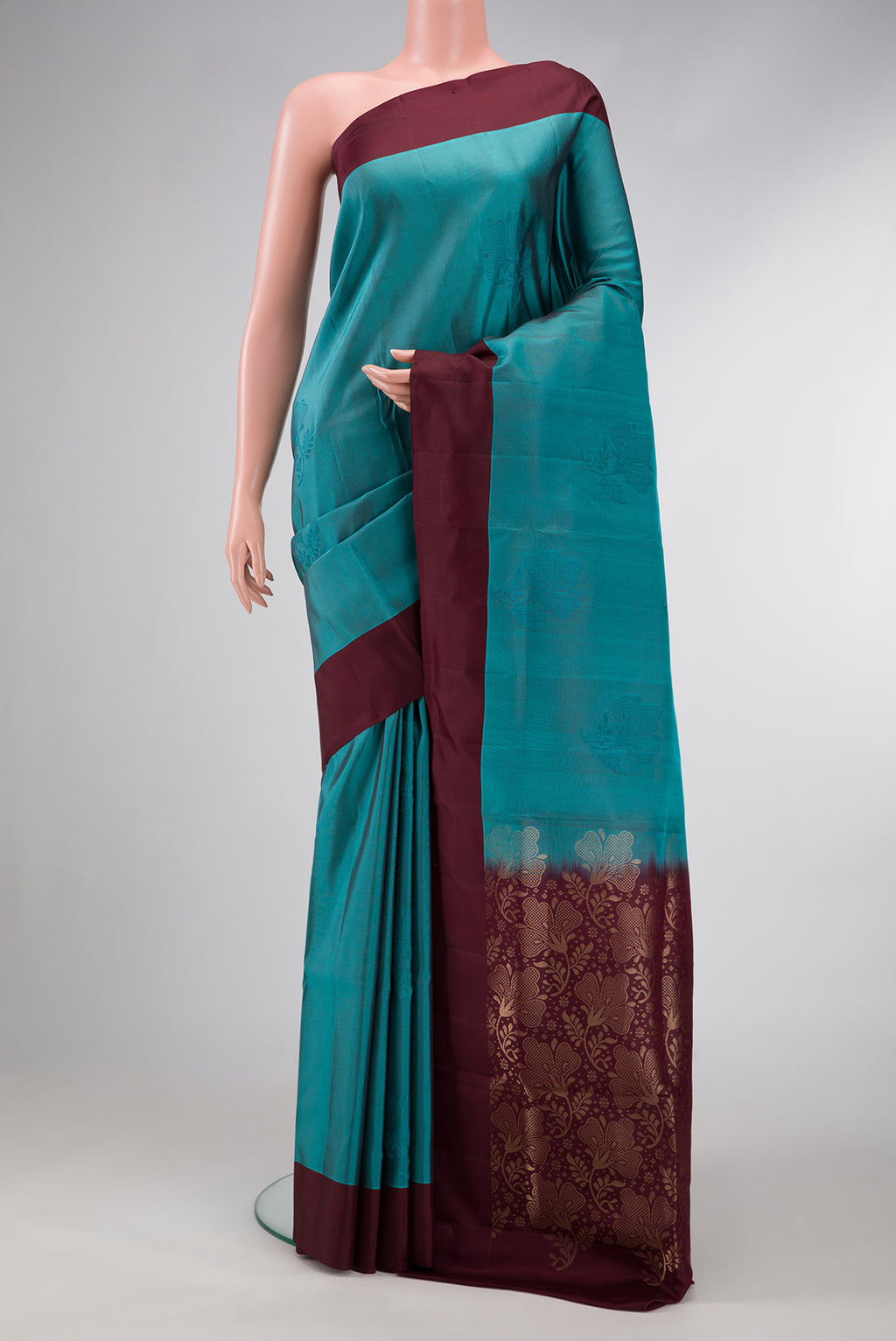 Peacock Blue Dual Tone Soft Silk Saree with Thread Butta on the body and Plain Border.  displayed on a mannequin