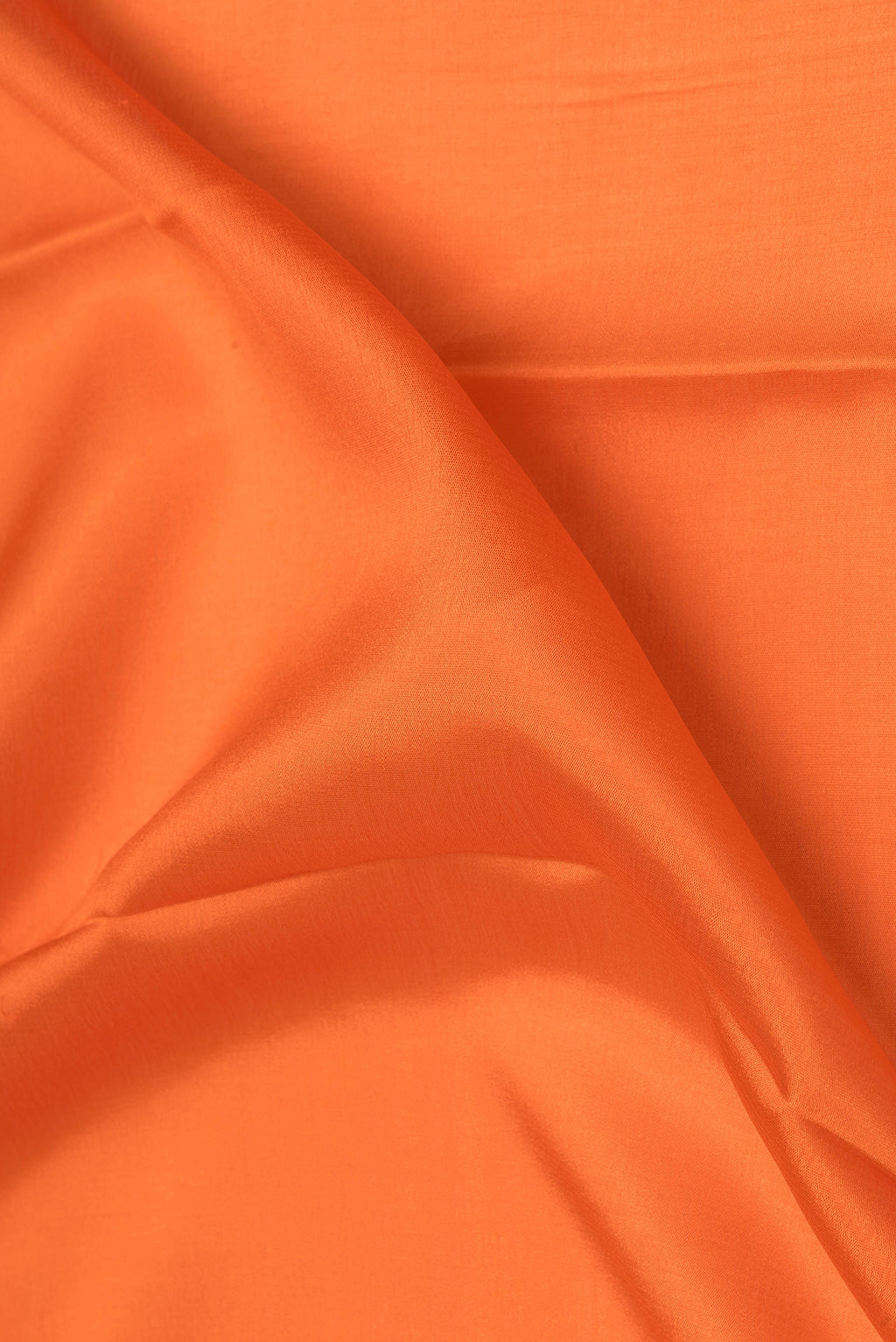 Close up of Orange Mysore Silk Saree with Plain Body and Zari Border.  displaying folds