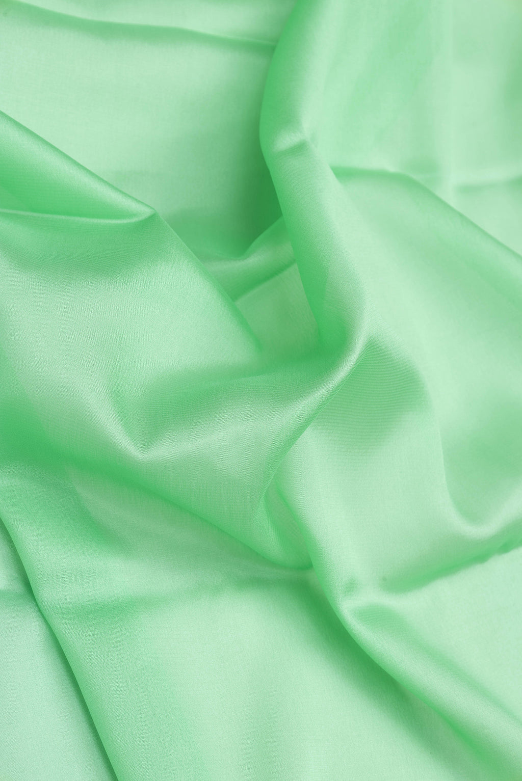 Close up of Sea Green Dual Tone Mysore Silk Saree with Plain Body and Zari Border.  displaying folds