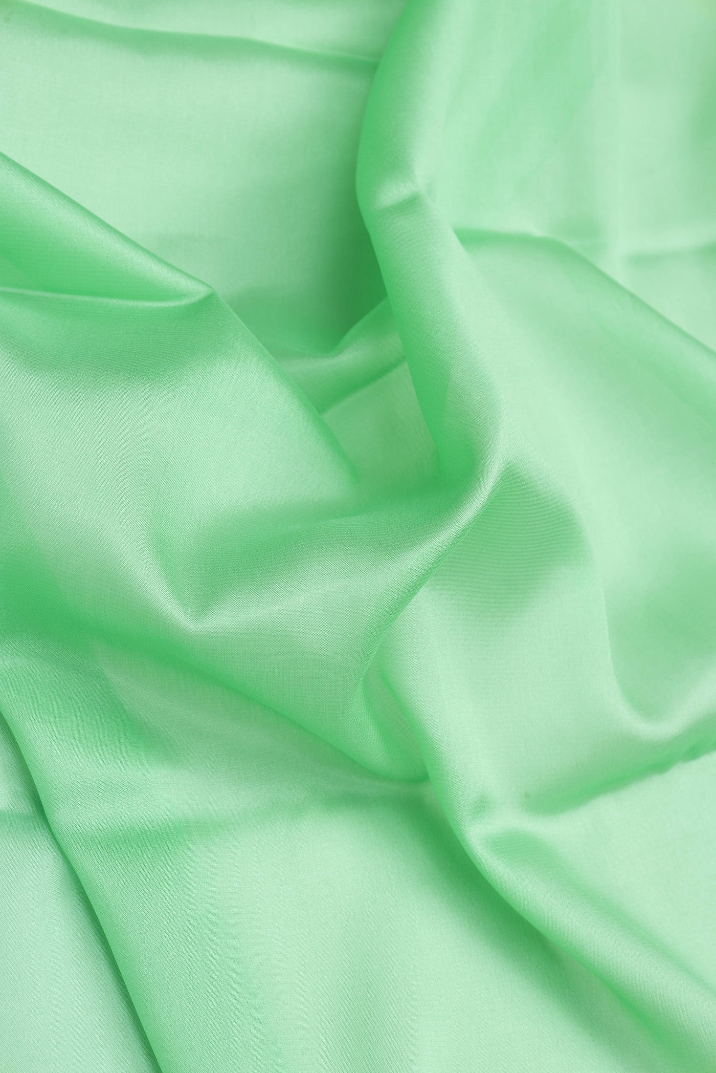 Close up of Sea Green Dual Tone Mysore Silk Saree with Plain Body and Zari Border.  displaying folds