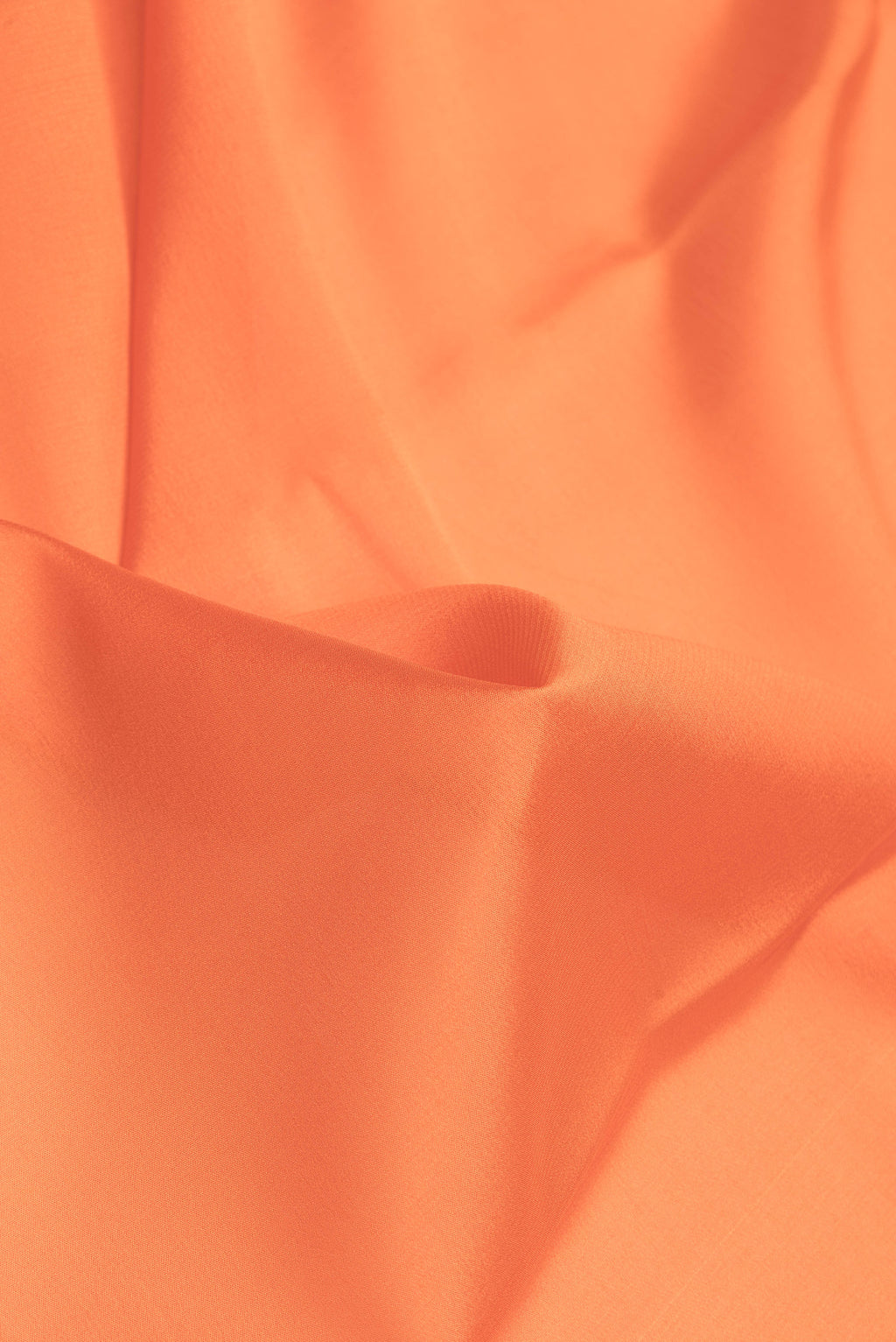 Close up of Orange Dual Tone Mysore Silk Saree with Plain Body and Zari Border.  displaying folds