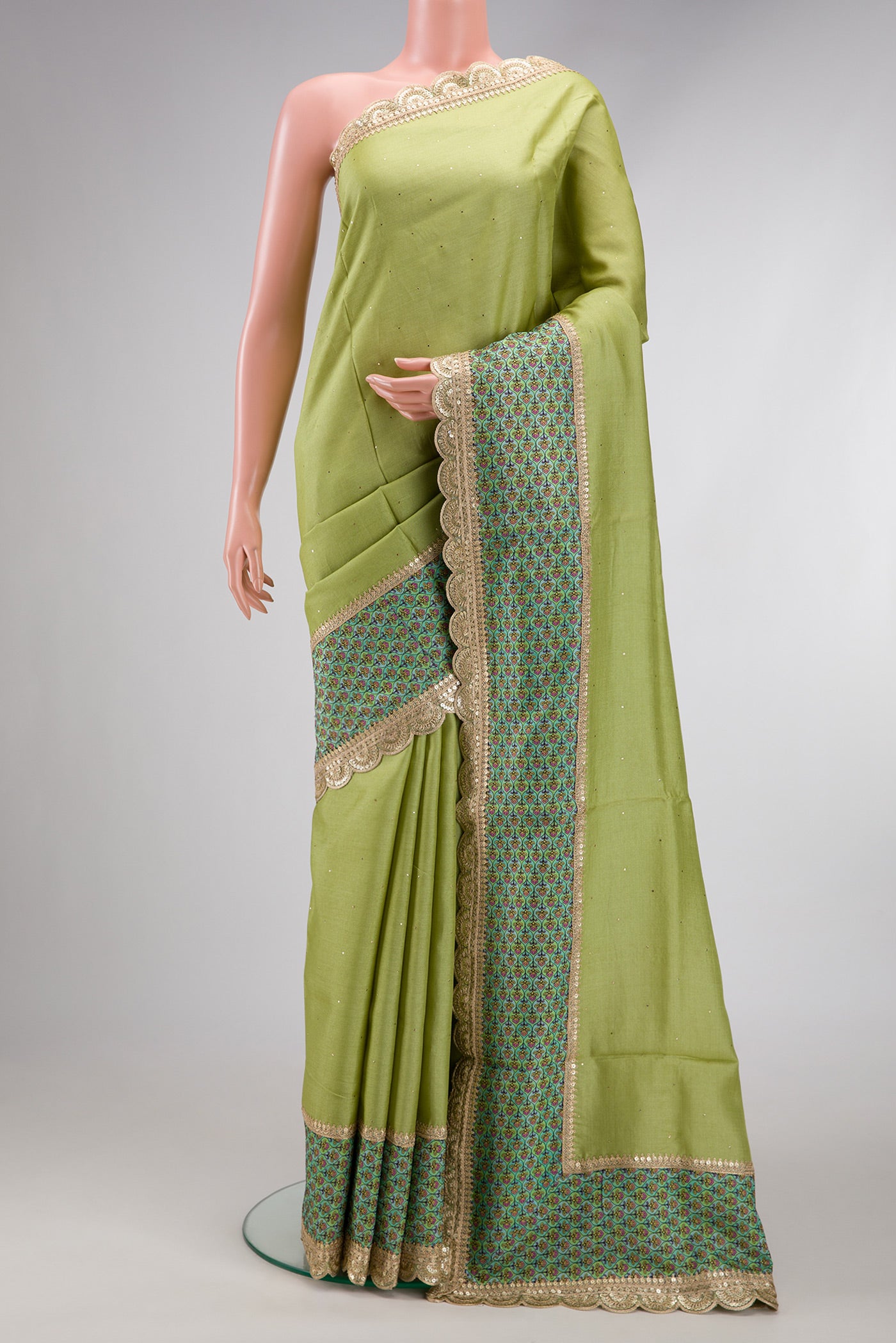 Pista Green Dual Tone Tussar Silk Saree with Embroidery on the body and Fancy Border.  displayed on a mannequin