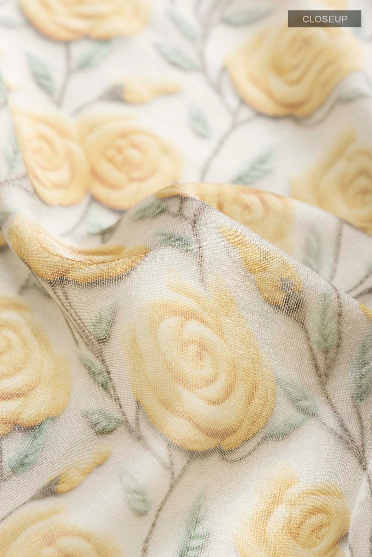 Close up of Grey Mysore Georgette Saree with Printed design on the body and Embroidery Border displaying folds