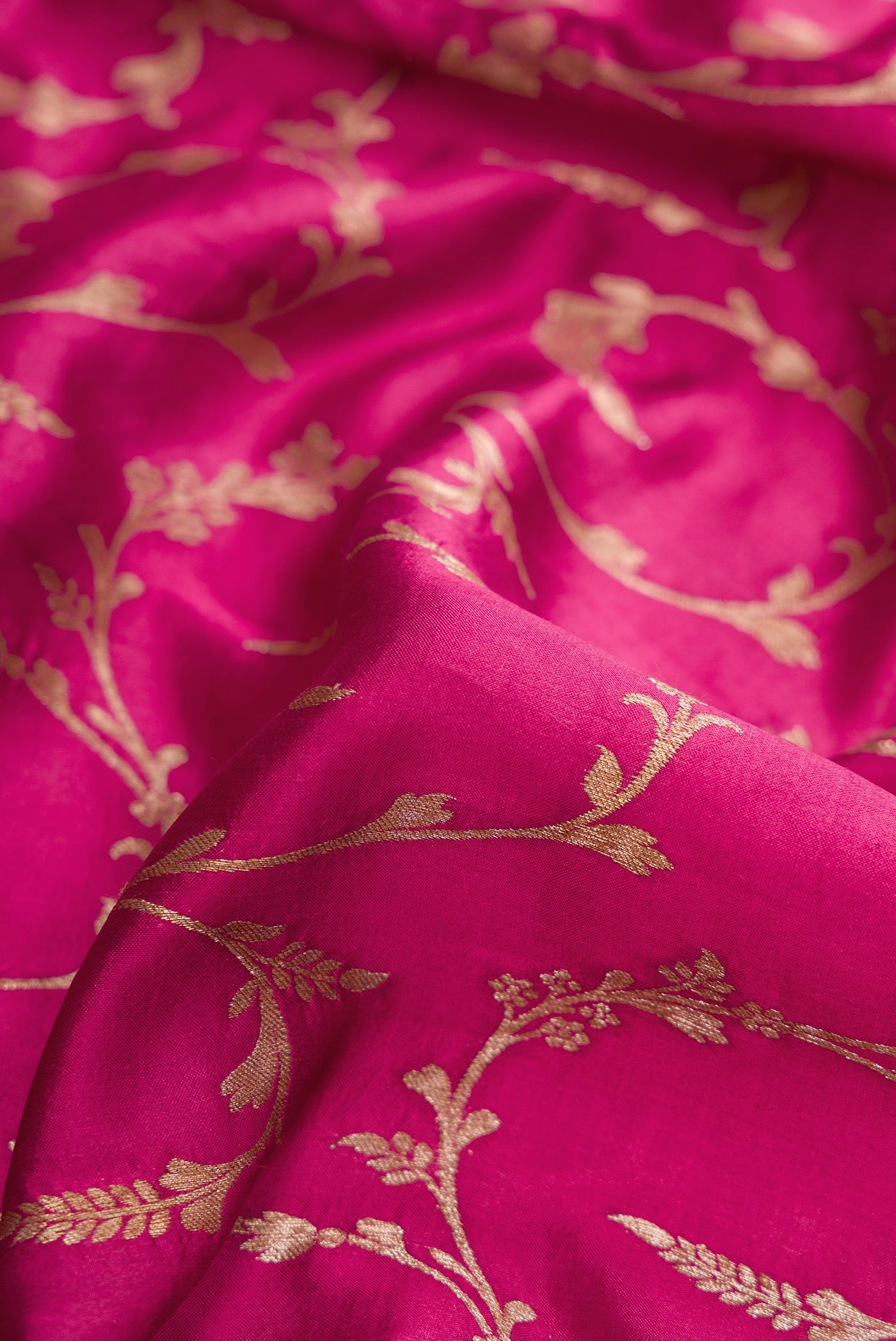 Close up of Magenta Dual Tone Tussar Silk Saree with Zari Brocade on the body and Fancy Border.  displaying folds