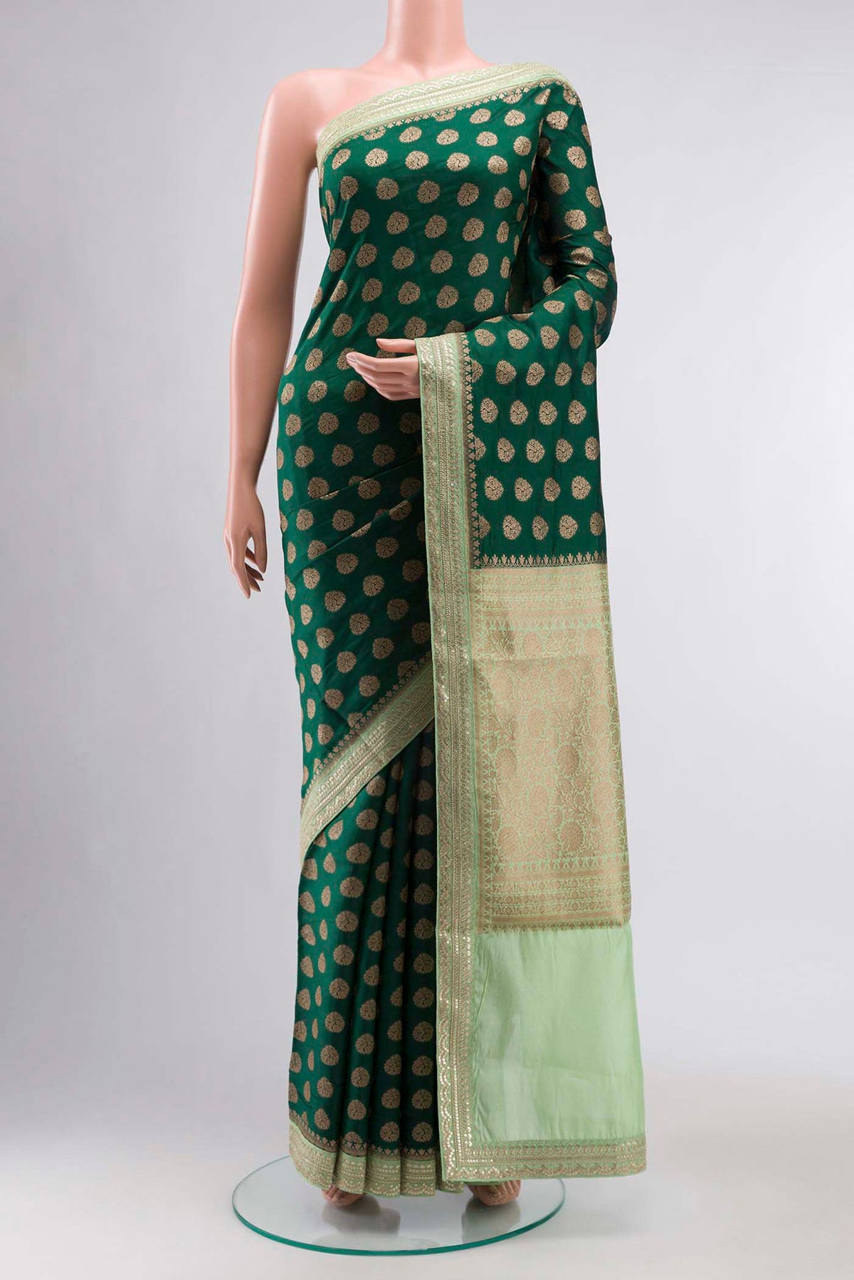 Green Banarasi Raw Silk Saree with Zari Butta on the body and Embroidery Border displayed on a mannequin