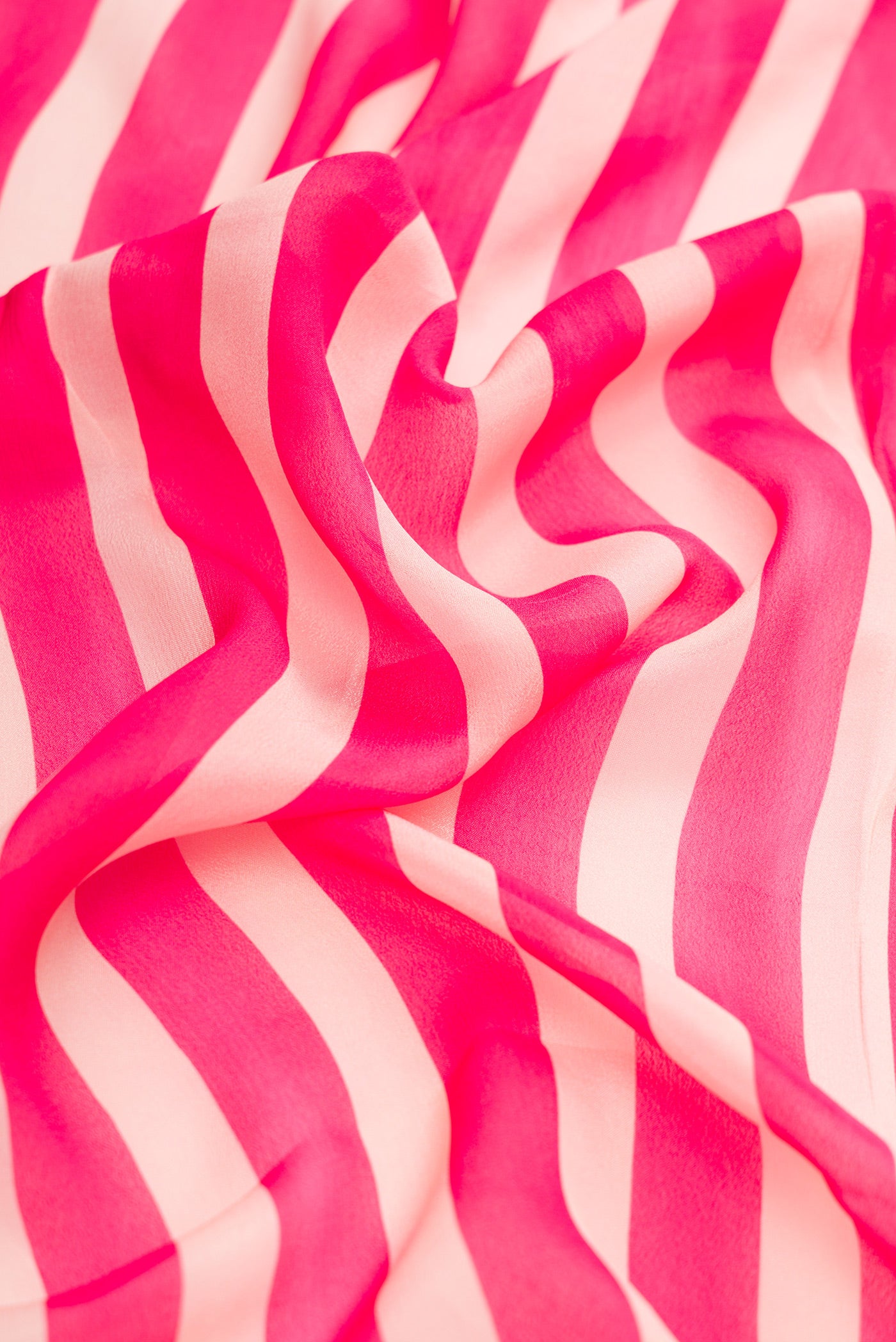 Close up of Beige and Pink Color Mysore Crepe Saree with Stripes on the body and Embroidery Border.  displaying folds