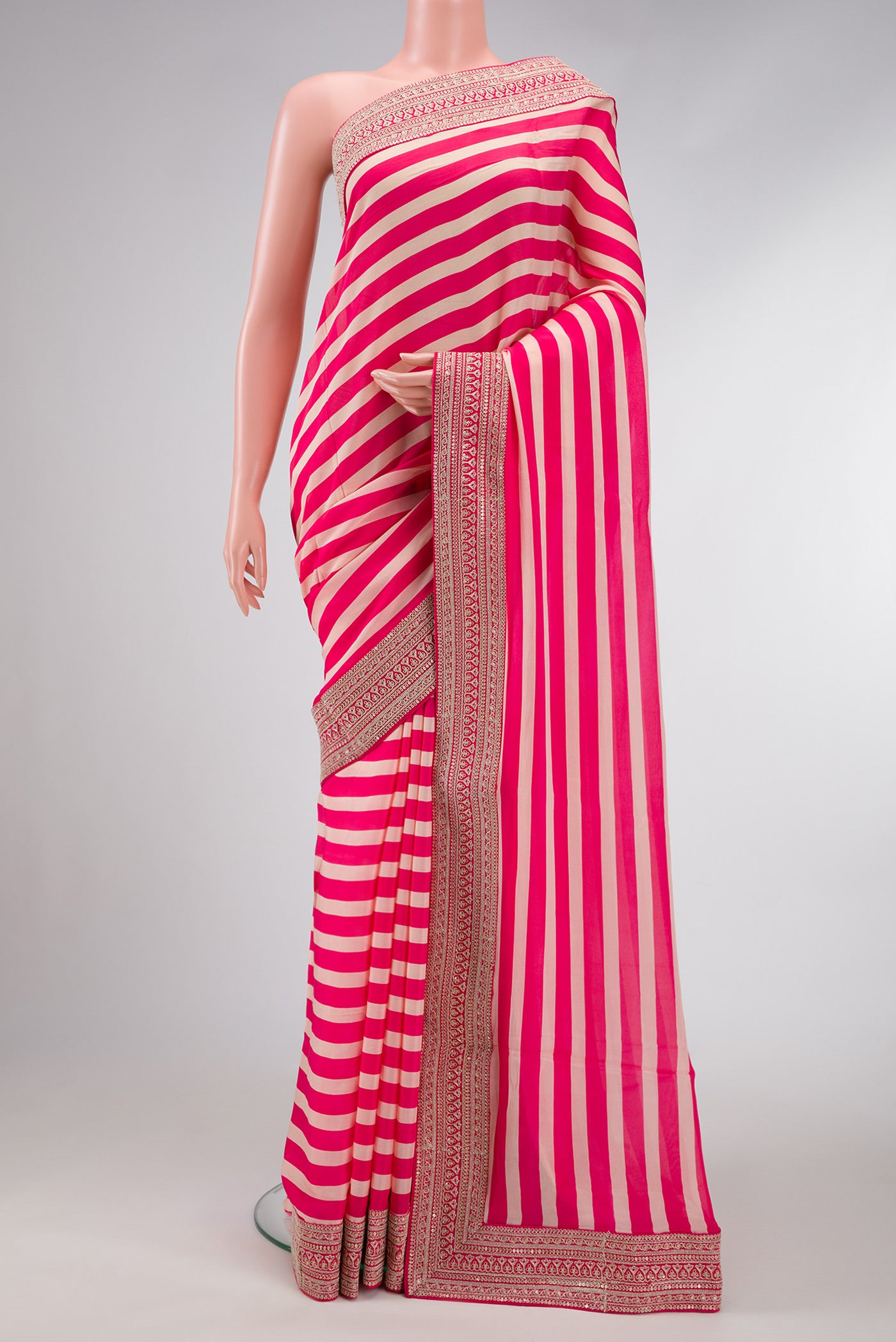Beige and Pink Color Mysore Crepe Saree with Stripes on the body and Embroidery Border.  displayed on a mannequin