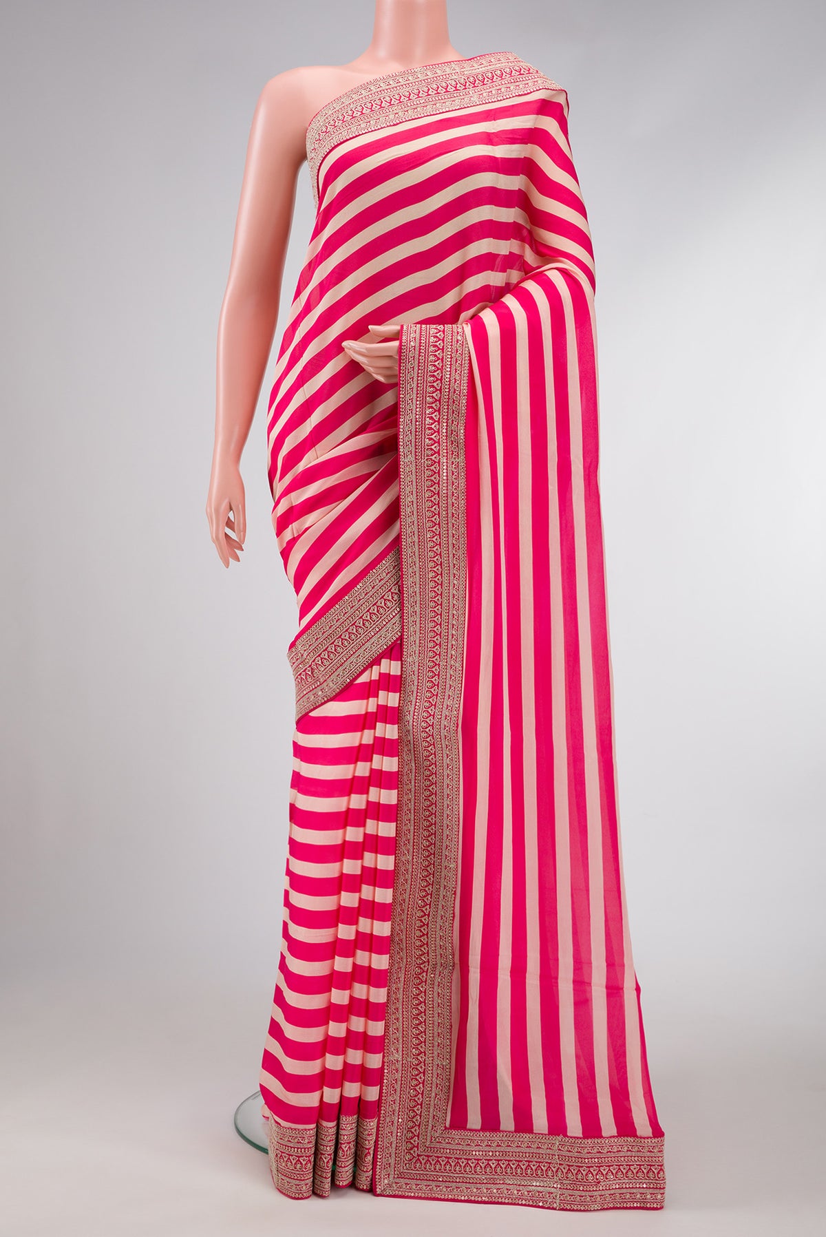 Beige and Pink Color Mysore Crepe Saree with Stripes on the body and Embroidery Border.  displayed on a mannequin