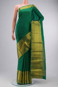 Green Kanchipuram Silk Saree with Plain Body and Zari Border displayed on a mannequin