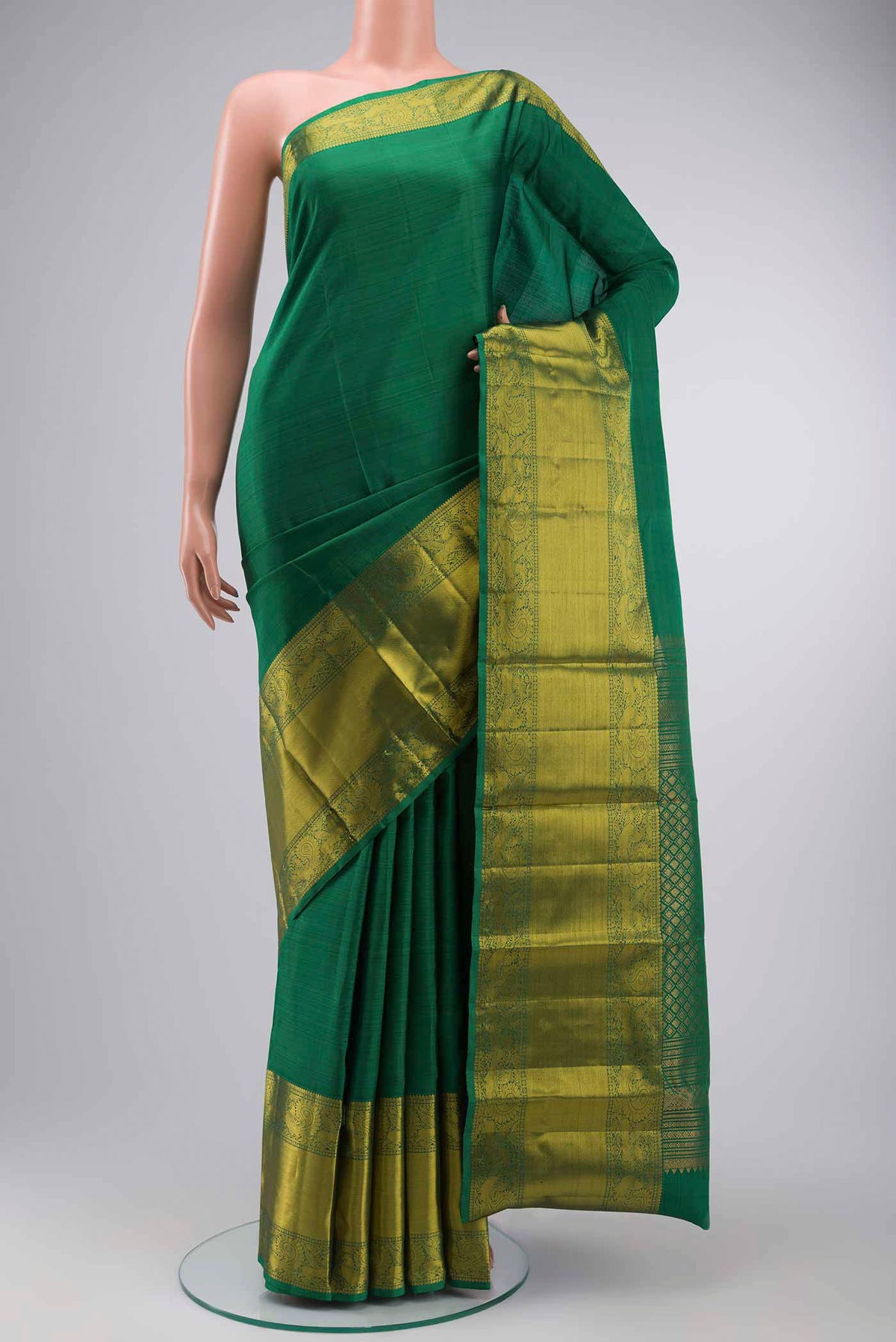 Green Kanchipuram Silk Saree with Plain Body and Zari Border displayed on a mannequin