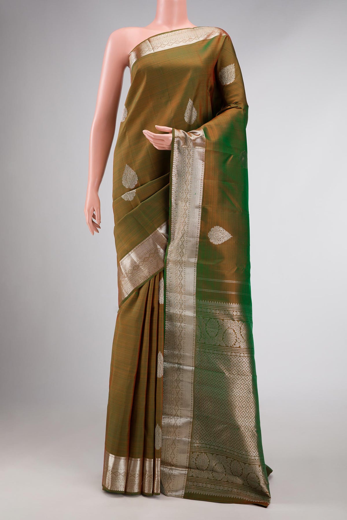 Green Dual Tone Kanchipuram Silk Saree with Zari Butta on the body and Zari Border displayed on a mannequin