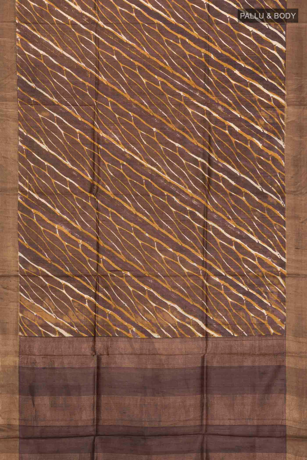 Flat view of Brown Tussar Silk Saree with Printed design on the body and Zari Border