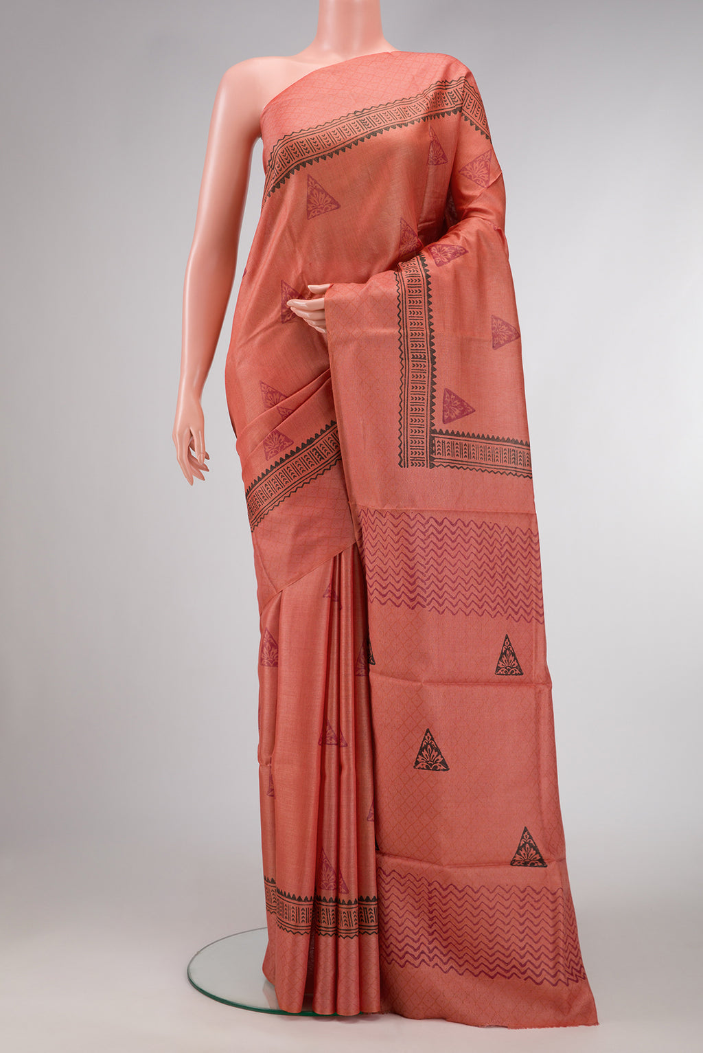 Brick Orange Dual Tone Tussar Silk Saree with Printed design on the body and Fancy Border.  displayed on a mannequin