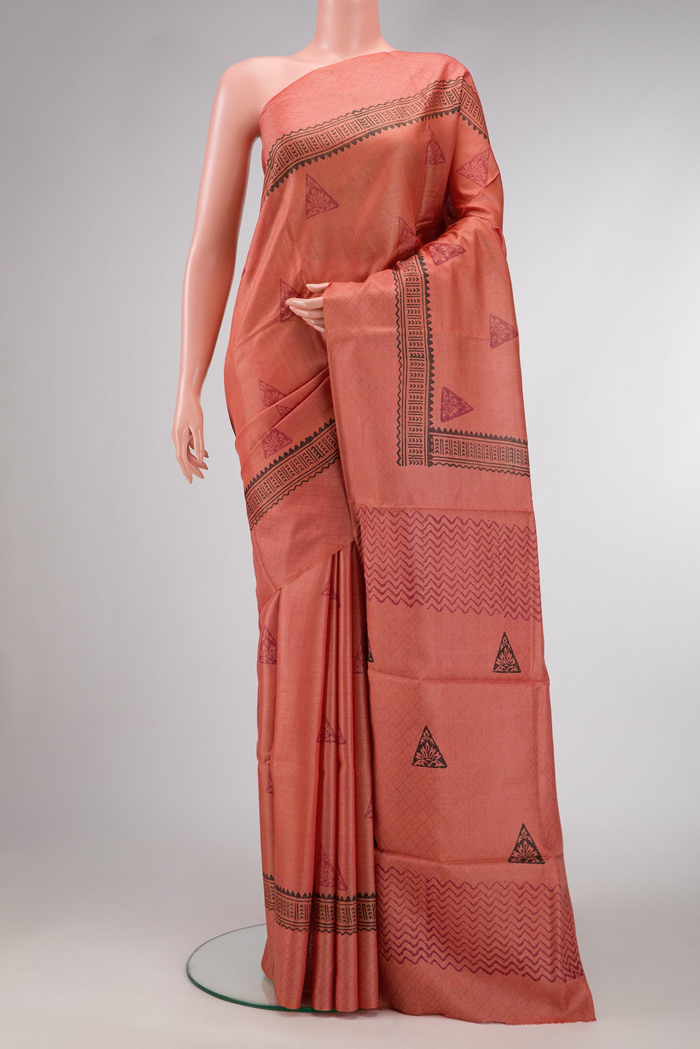 Brick Orange Dual Tone Tussar Silk Saree with Printed design on the body and Fancy Border.  displayed on a mannequin