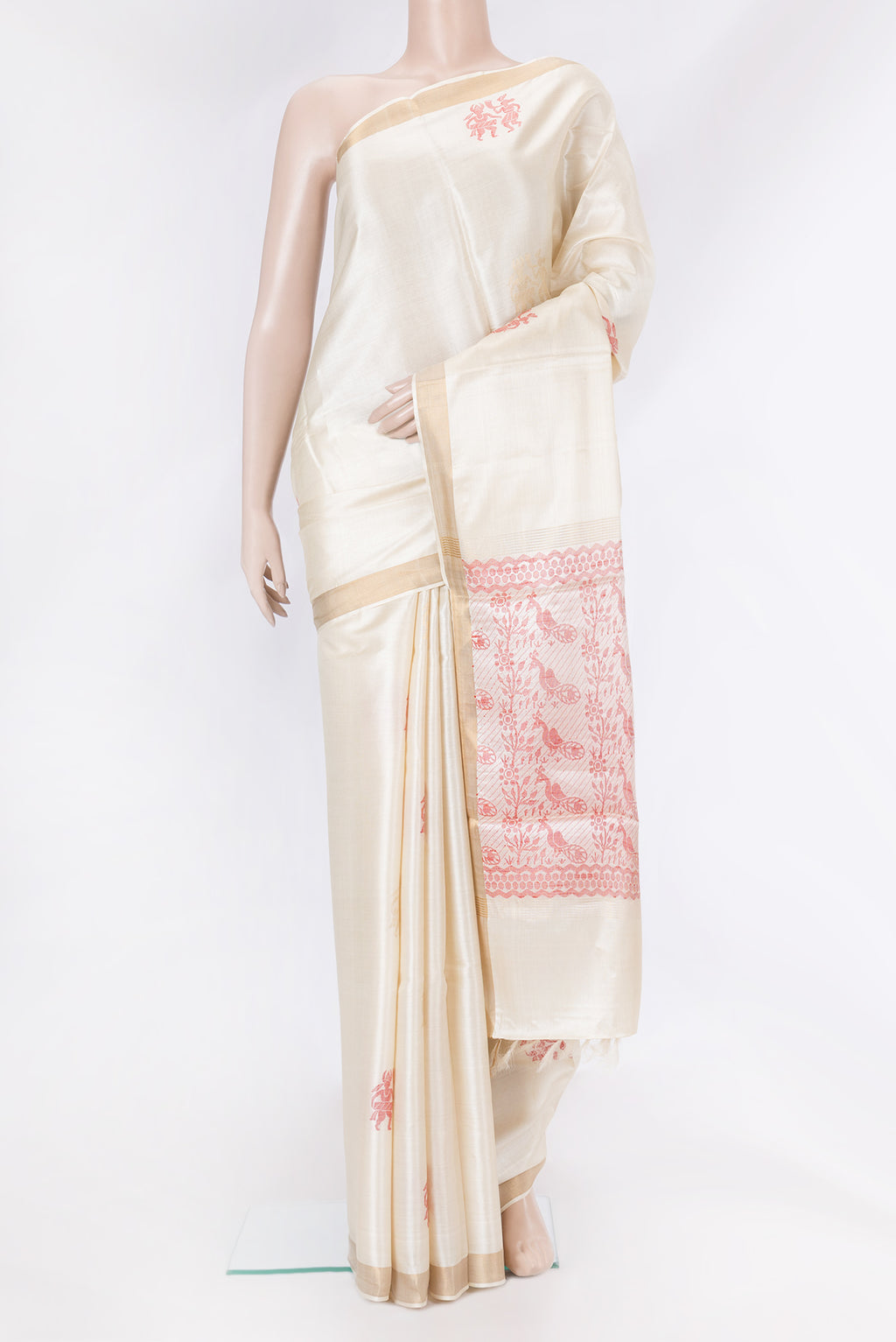 Cream Tussar Silk Saree with Zari And Thread Butta on the body and Zari Border.  displayed on a mannequin