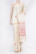 Cream Tussar Silk Saree with Zari And Thread Butta on the body and Zari Border.  displayed on a mannequin