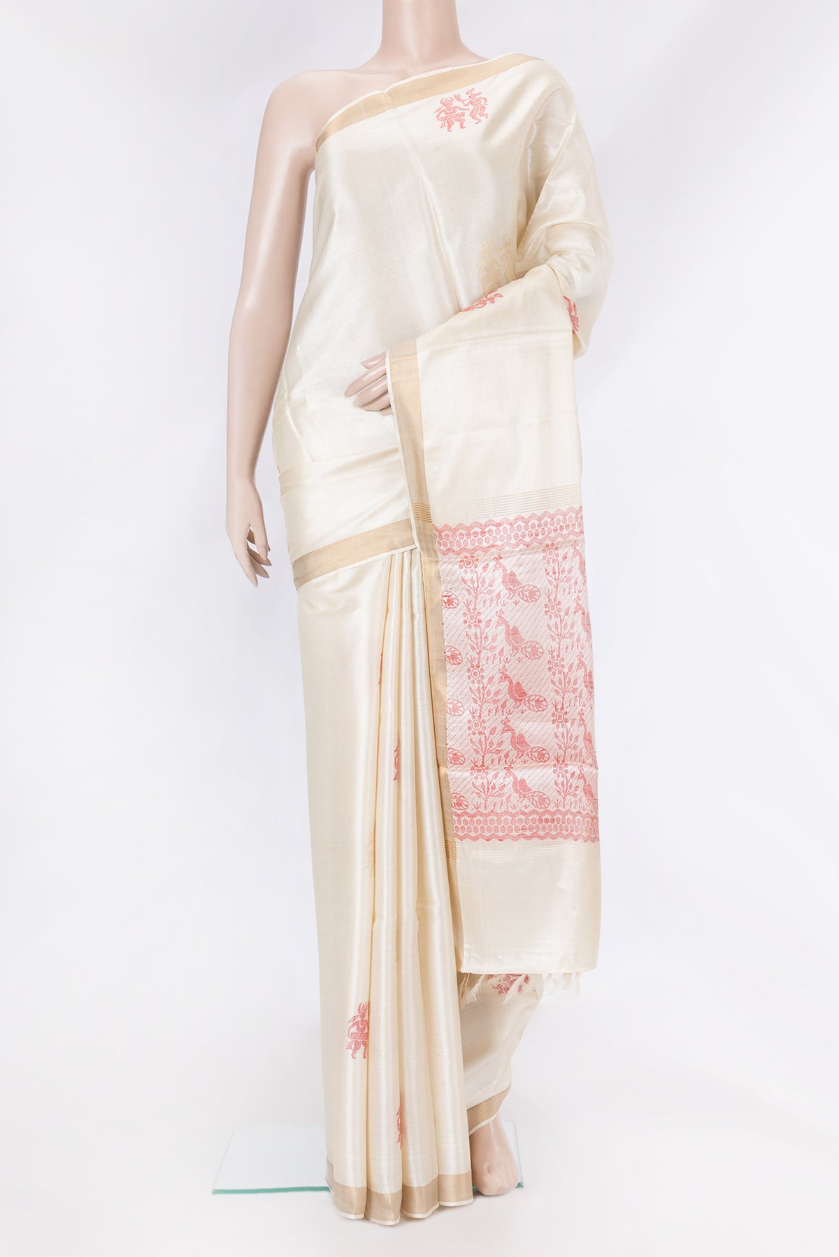 Cream Tussar Silk Saree with Zari And Thread Butta on the body and Zari Border.  displayed on a mannequin
