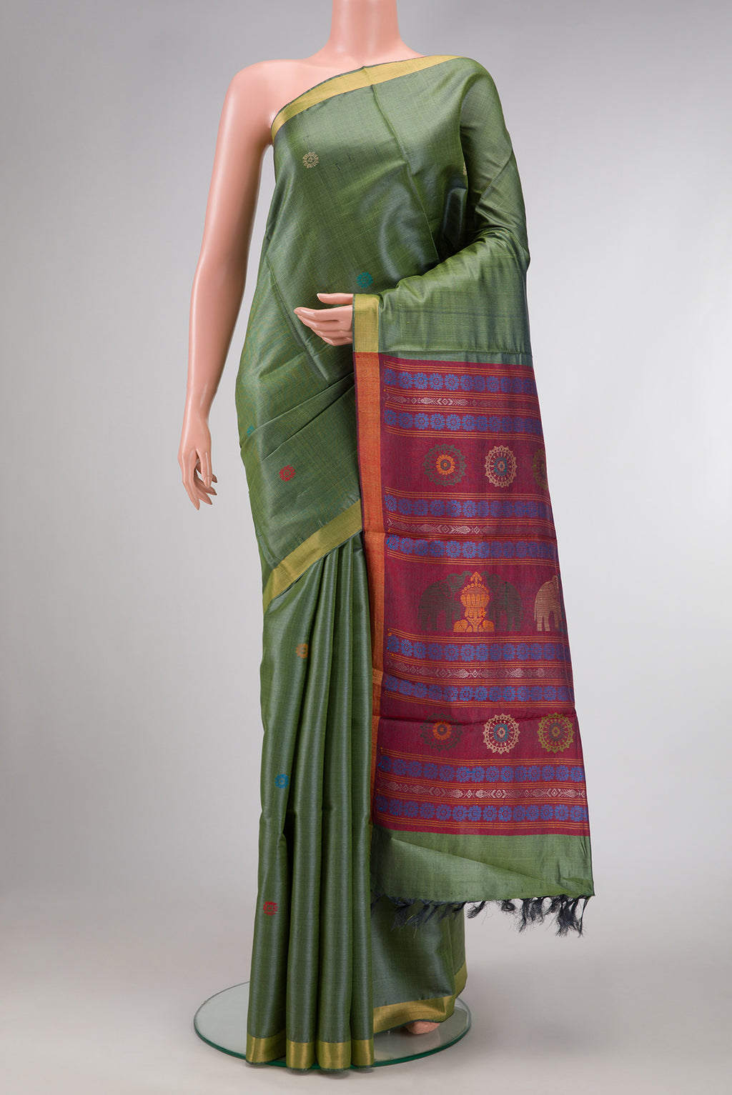 Mehandi Green Dual Tone Tussar Silk Saree with Thread Butta on the body and Zari Border.  displayed on a mannequin