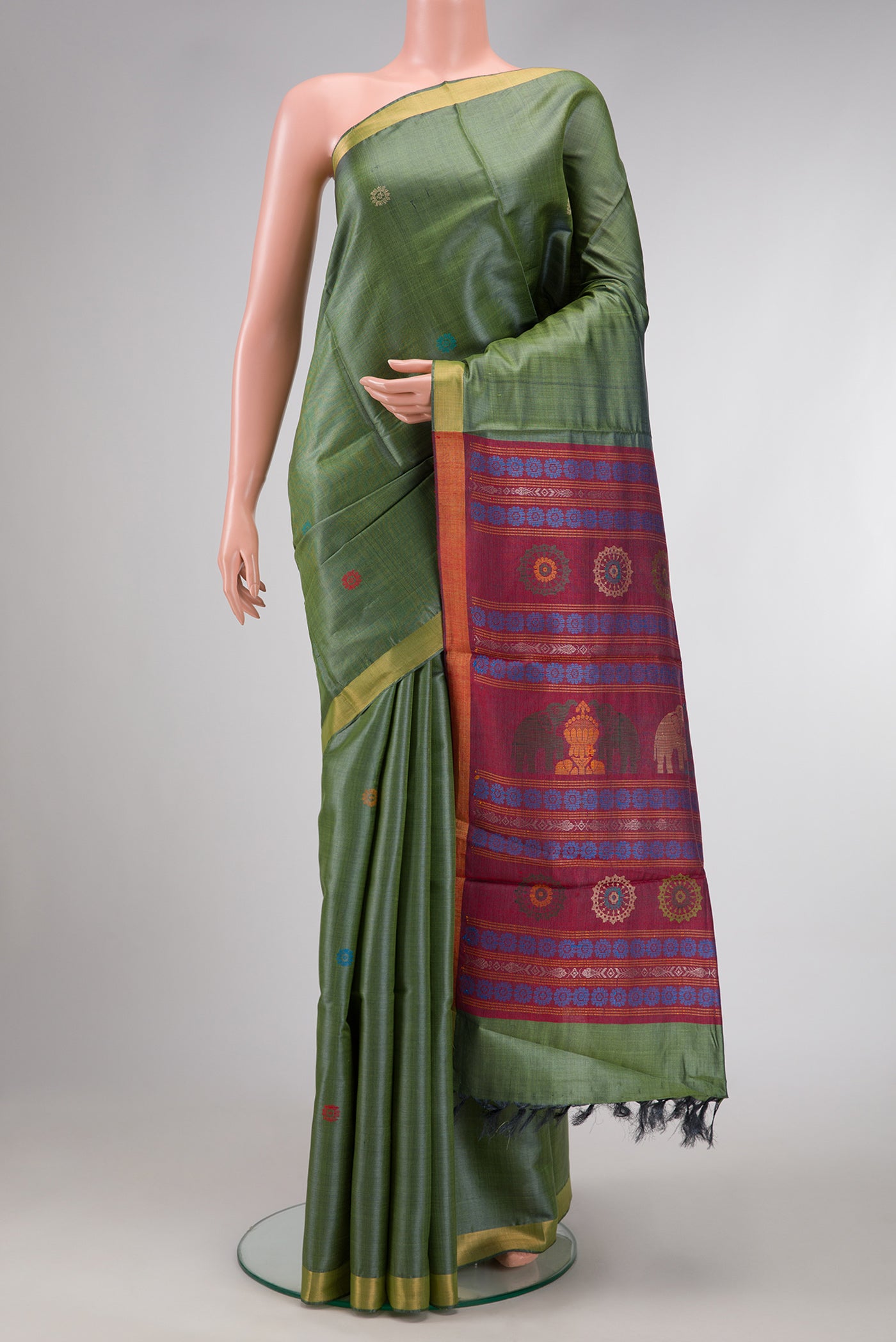 Mehandi Green Dual Tone Tussar Silk Saree with Thread Butta on the body and Zari Border.  displayed on a mannequin