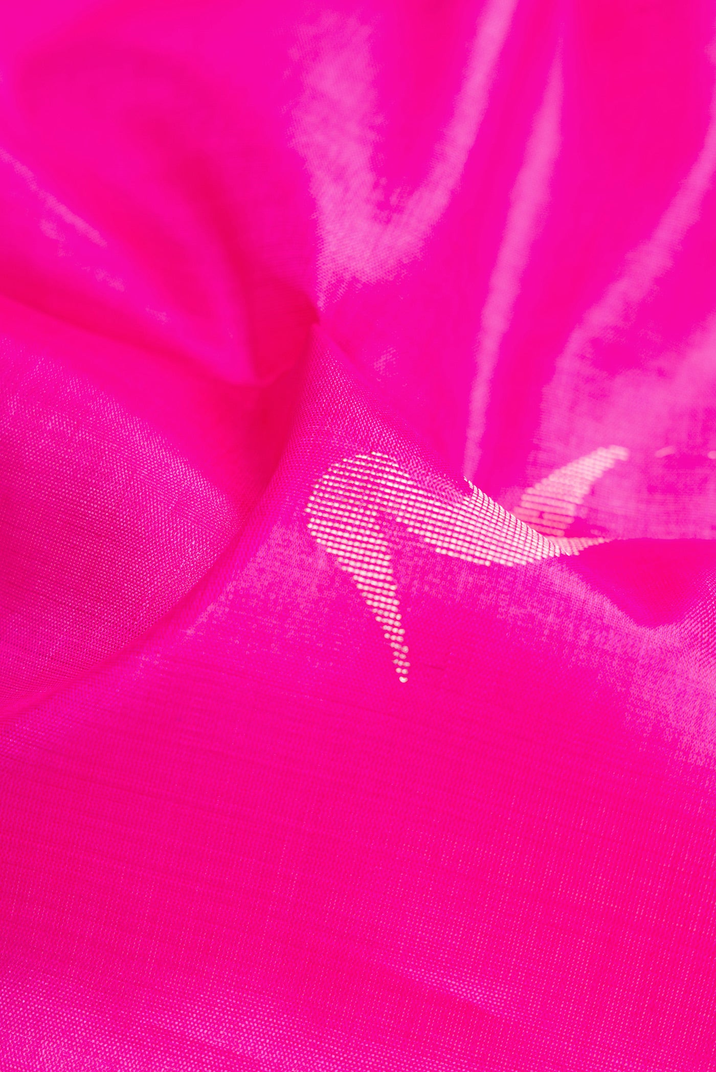 Close up of Pink Dual Tone Tussar Silk Saree with Zari Butta on the body and Zari Border.  displaying folds