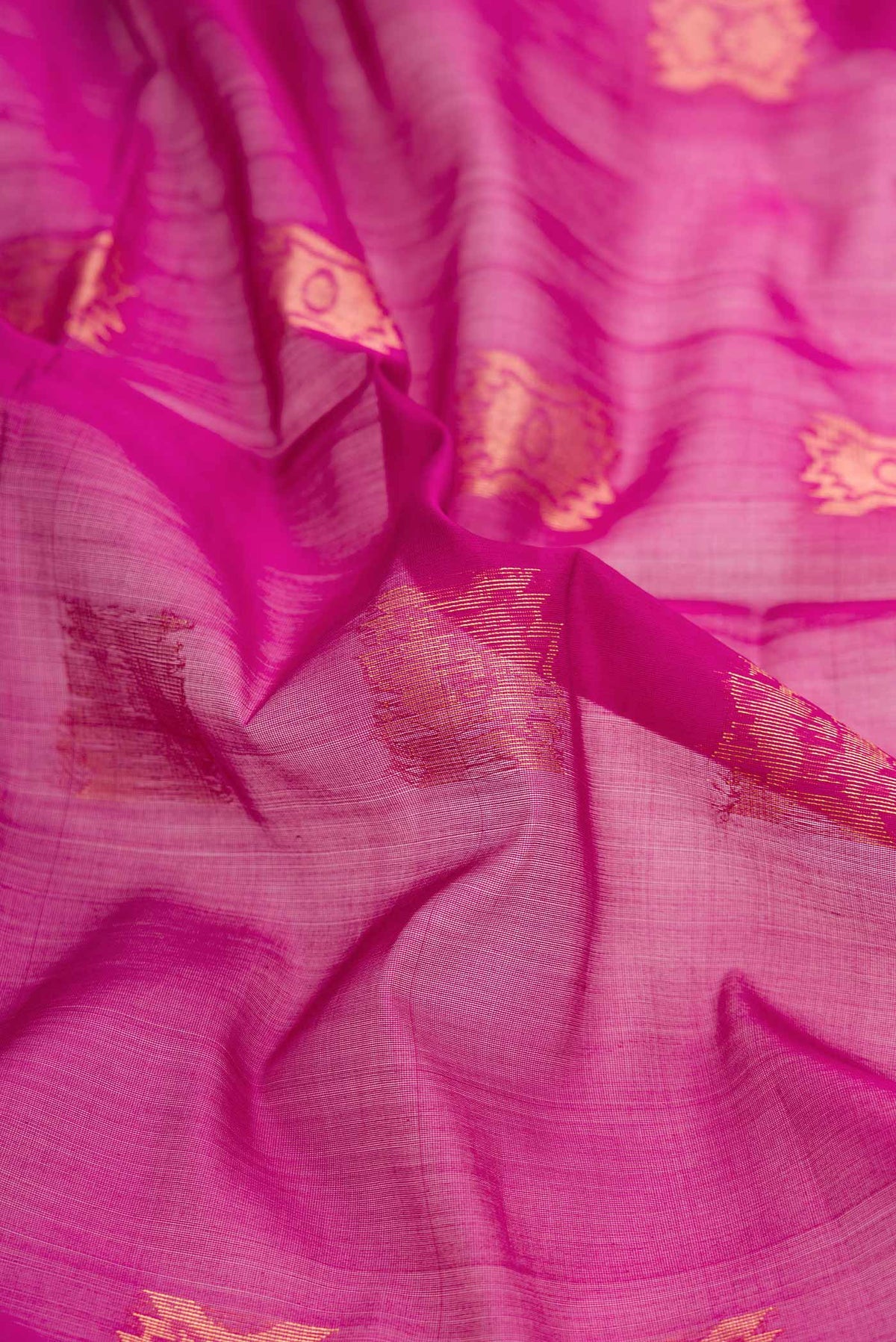 Close up of Magenta Dual Tone Silk Cotton Saree with Zari Butta on the body and Zari Border displaying folds