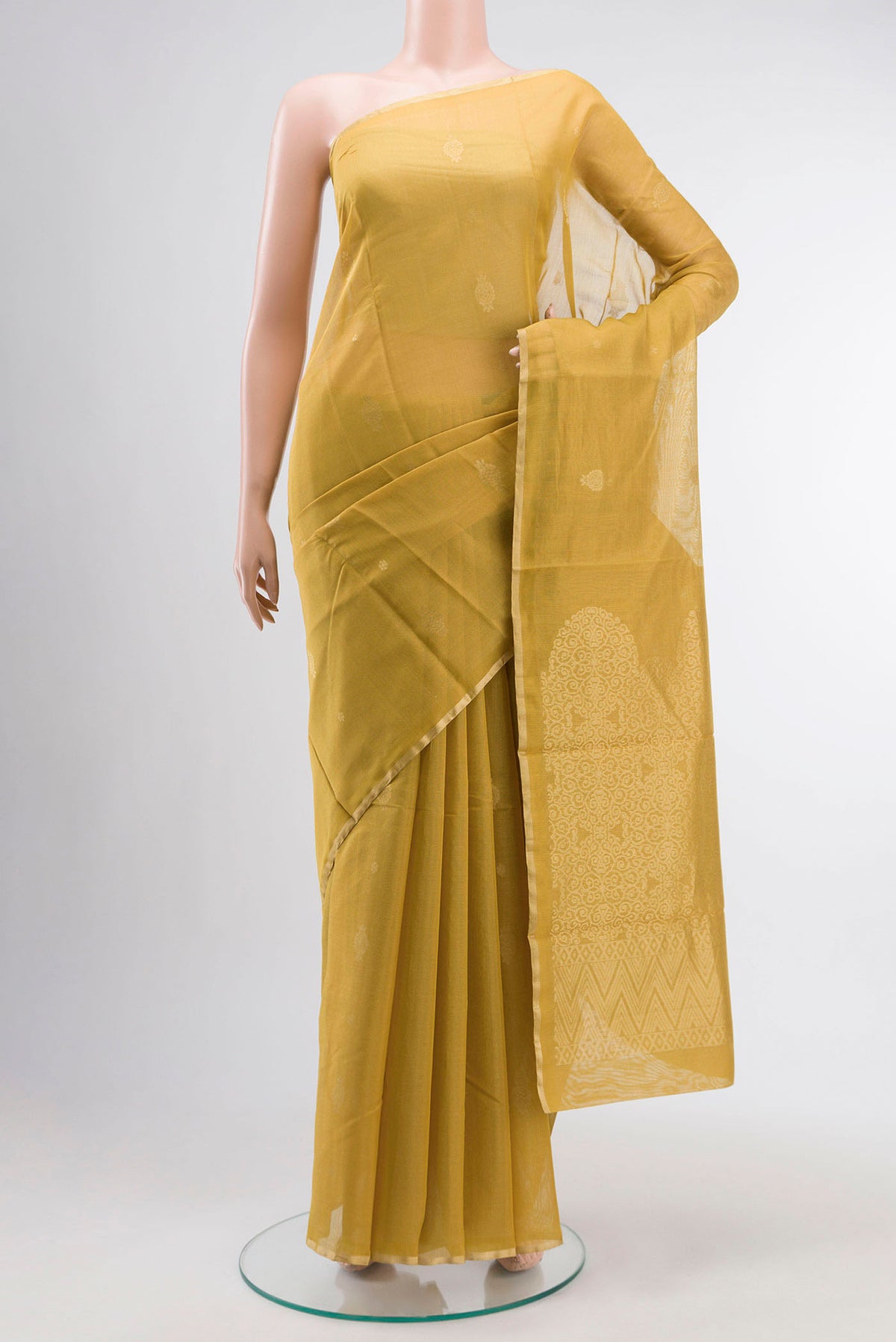 Mustard Silk Cotton Saree with Zari Butta on the body and Zari Border displayed on a mannequin