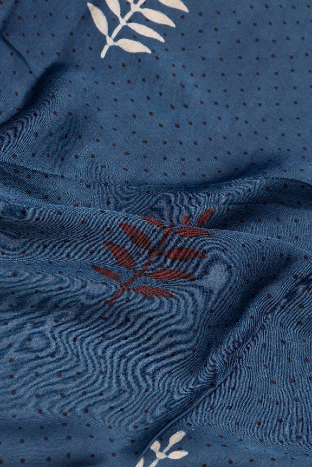 Close up of Indigo Dual Tone Blended Crepe Saree with Ajrakh Print on the body and Fancy Border.  displaying folds