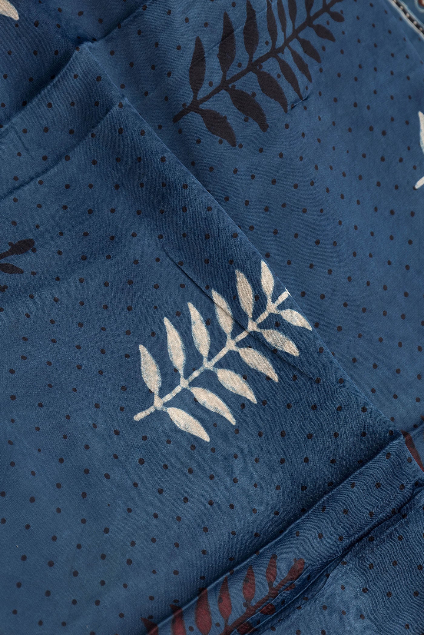 Close up of Indigo Dual Tone Blended Crepe Saree with Ajrakh Print on the body and Fancy Border.  displaying folds