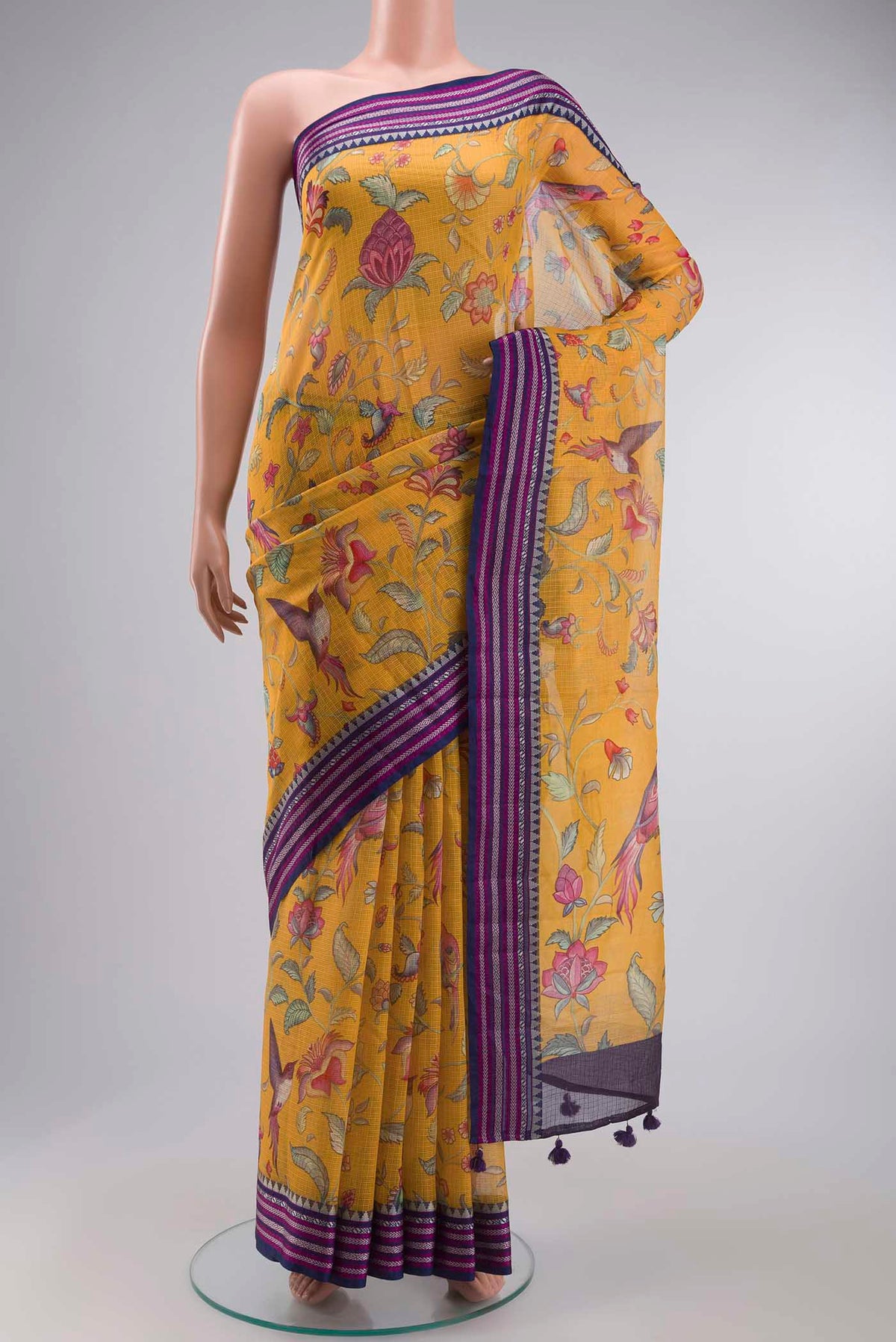 Yellow Silk Cotton Saree with Printed design on the body and Thread Border displayed on a mannequin