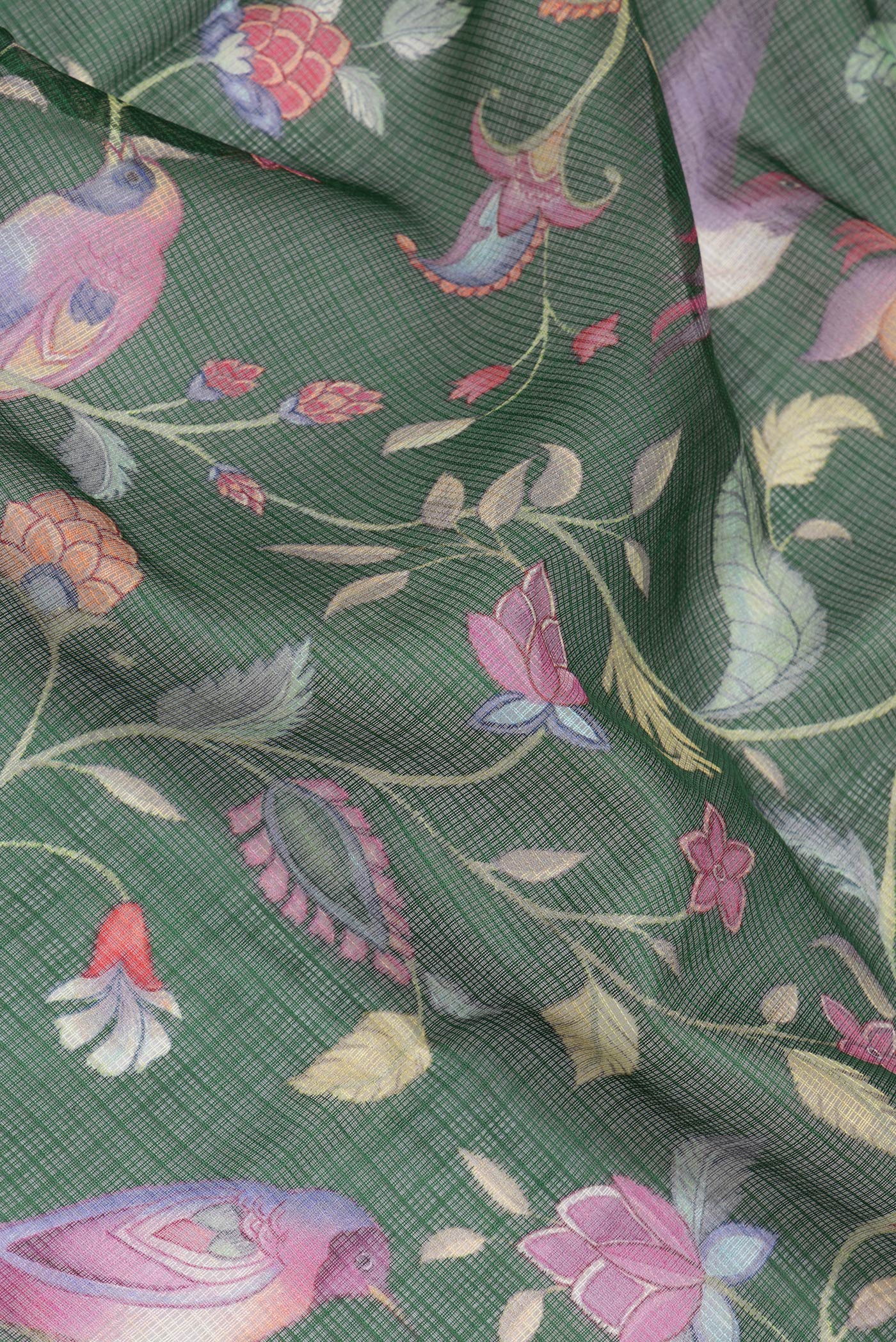 Close up of Green Kota Silk Saree with Floral Print on the body and Thread Border.  displaying folds