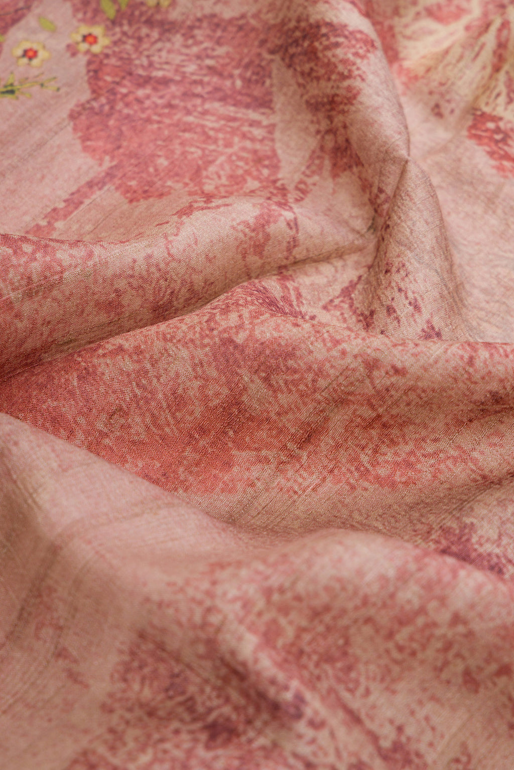 Close up of Pink Dual Tone Tussar Silk Saree with Printed design on the body and Zari Border.  displaying folds