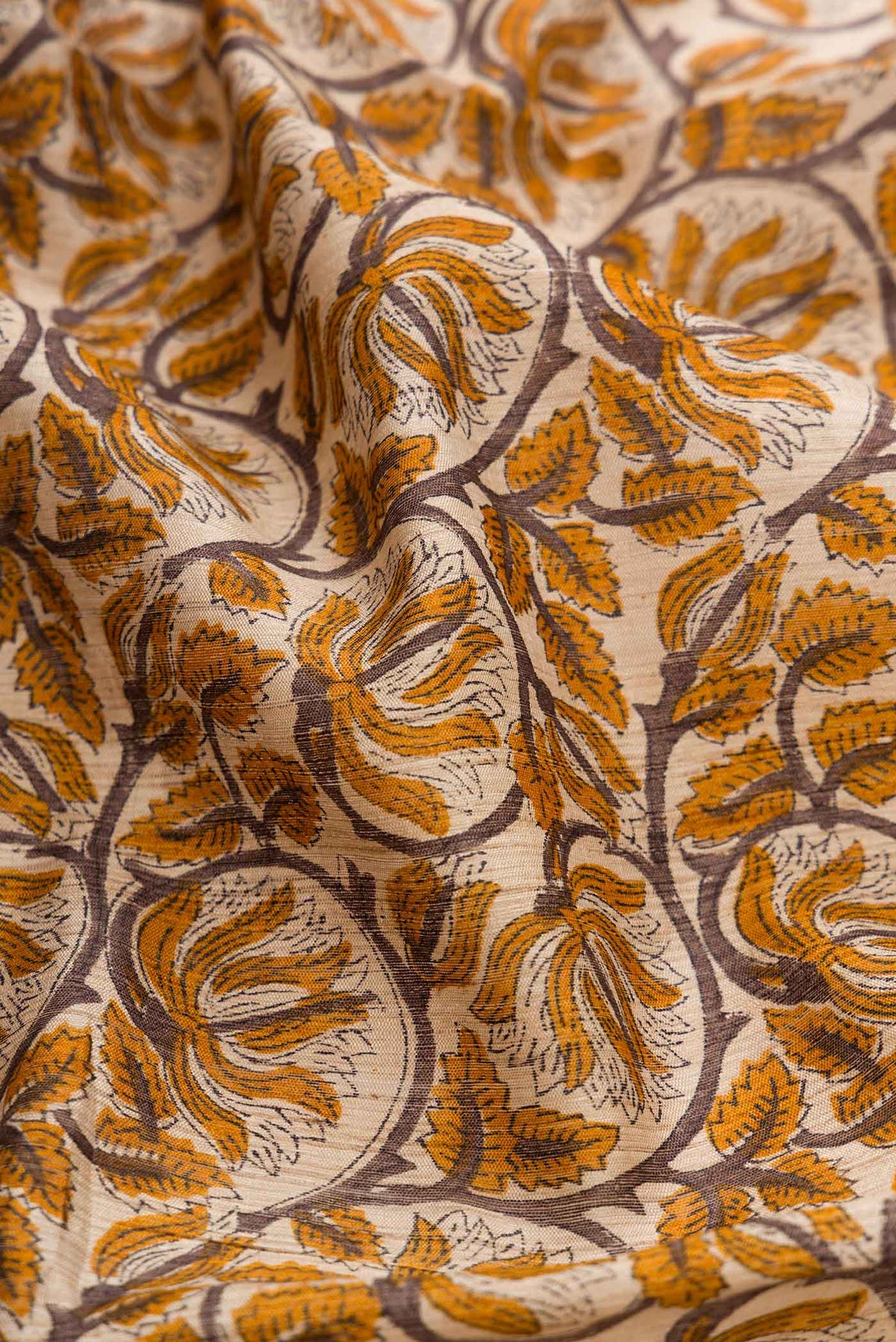 Close up of Beige Dual Tone Tussar Silk Saree with Printed design on the body and Zari Border displaying folds