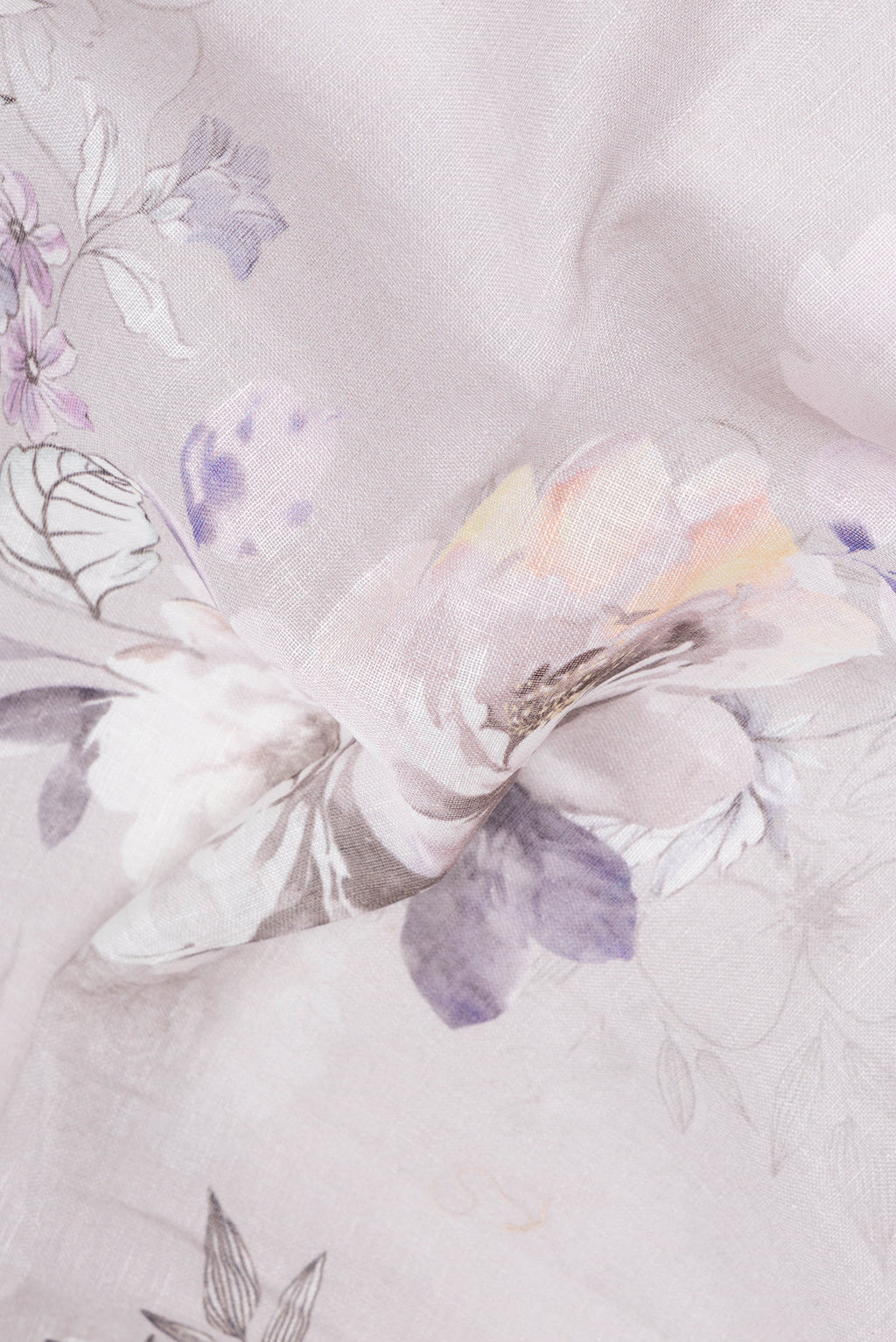 Close up of Grey Linen Saree with Floral Print on the body and Zari Border.  displaying folds