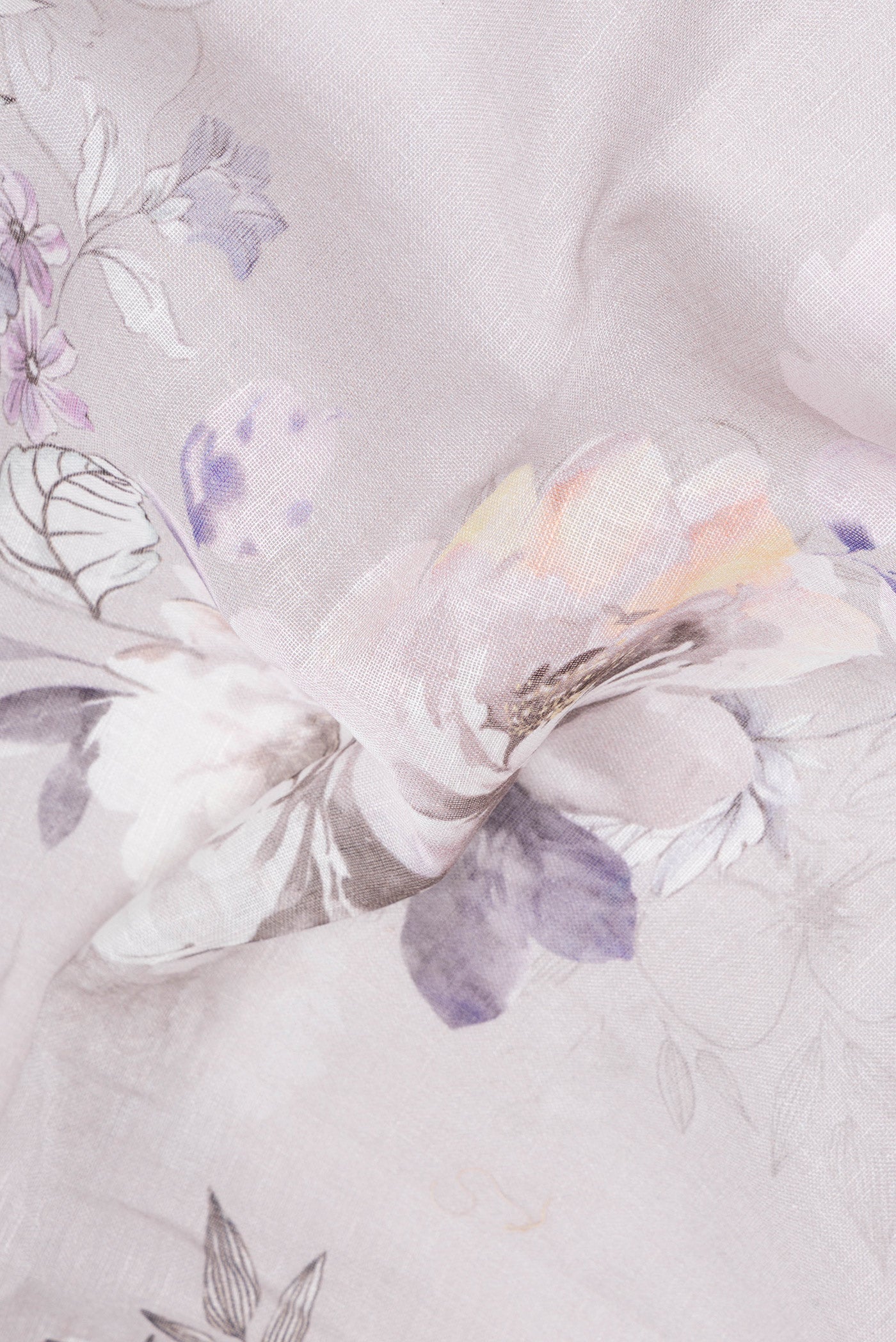 Close up of Grey Linen Saree with Floral Print on the body and Zari Border.  displaying folds