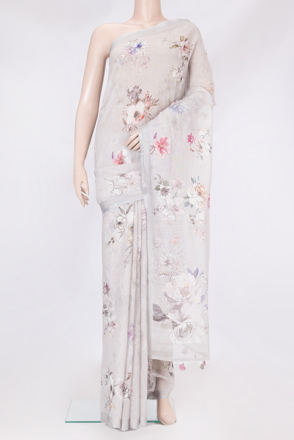 Grey Linen Saree with Floral Print on the body and Zari Border.  displayed on a mannequin
