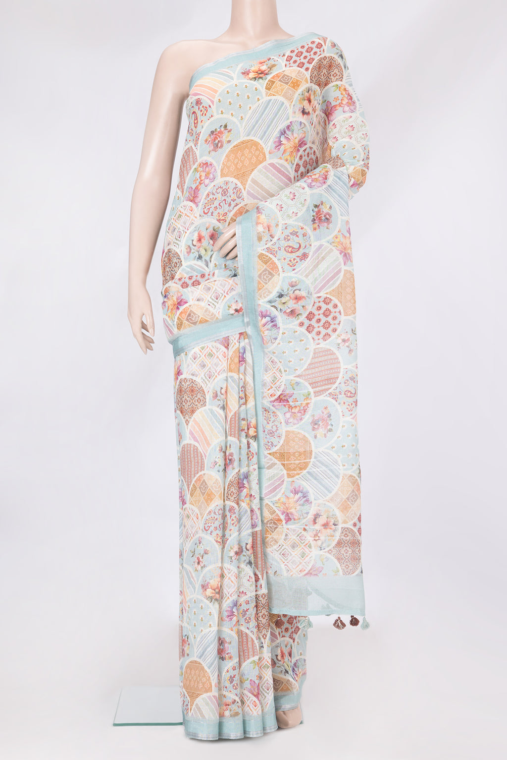 Sky Blue Linen Saree with Printed design on the body and Zari Border.  displayed on a mannequin
