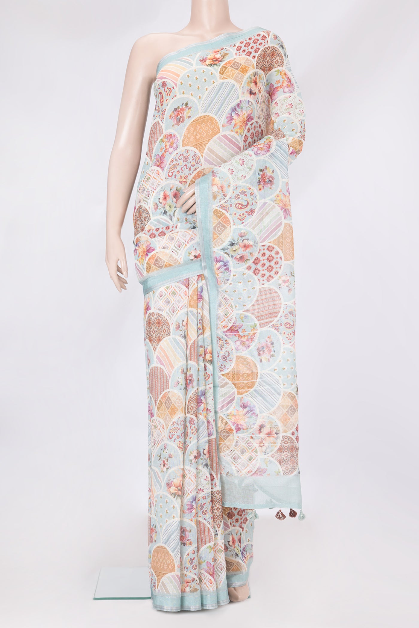 Sky Blue Linen Saree with Printed design on the body and Zari Border.  displayed on a mannequin