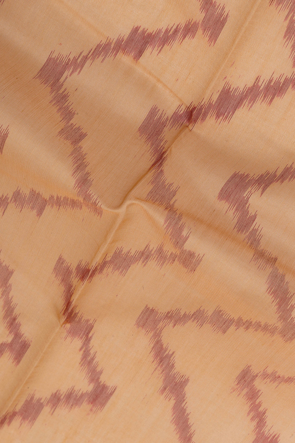 Close up of Sandal Silk Cotton Saree with Ikat Print on the body and Zari Border.  displaying folds