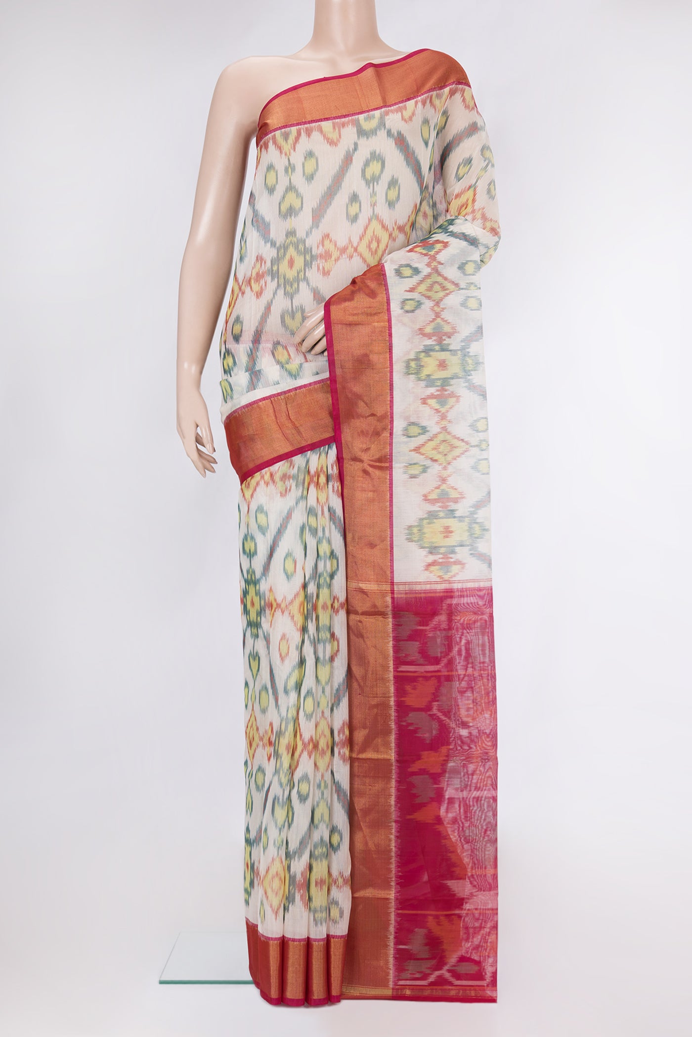 Off White Silk Cotton Saree with Ikat Print on the body and Zari Border.  displayed on a mannequin