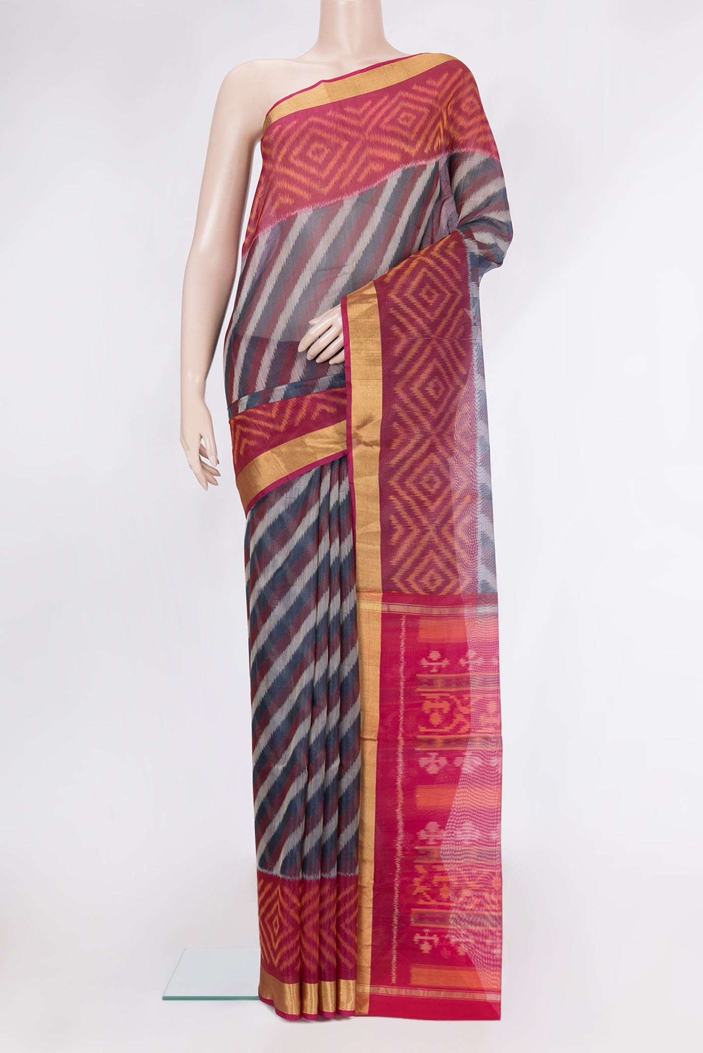 Peacock Blue Silk Cotton Saree with Ikat Print on the body and Ikat Border.  displayed on a mannequin